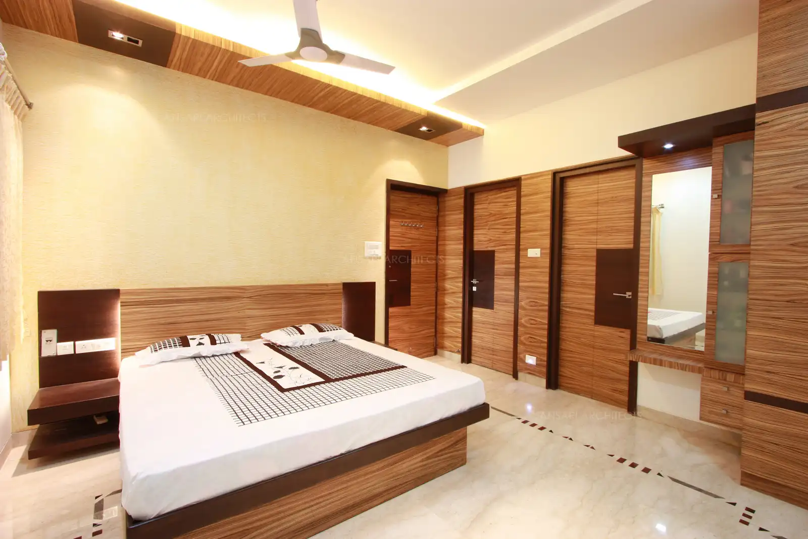 Bedroom-3 in the first floor has been designed with two contrast veneers named zebrano and wenge whose horizontal strips helps to widen up the area and gives a dramatic look.