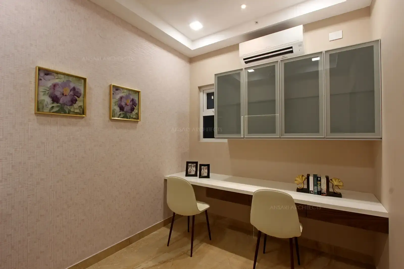 Study room is combined with puja, leather upholstered seatings with sleek table projection, the clean book cabinet looks neat and bold.