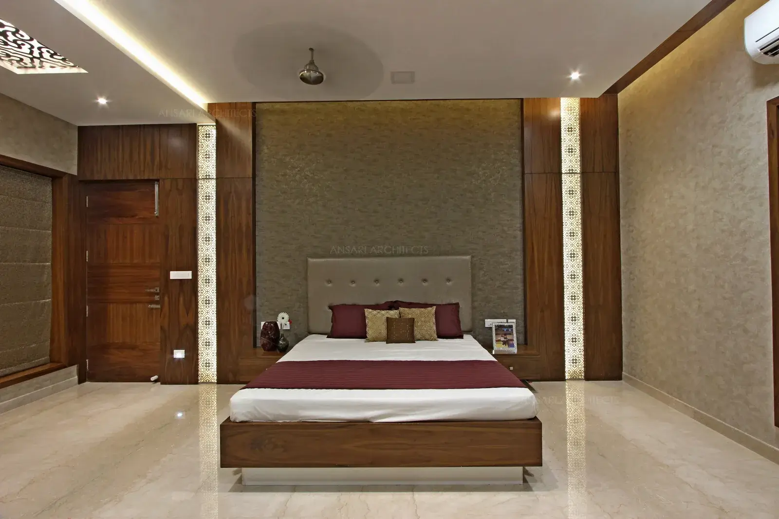 Wallpaper adds texture and dimension to this room, decorative panels with lighting ehances plush surfaces and rich colours enough for royalty.