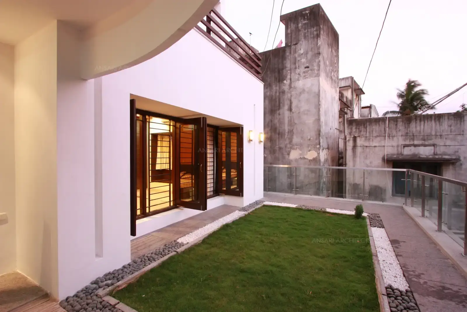 View of the Terrace Garden area which has lush green grass surrounded by pebble flooring which can be viewed from the french windows provided in the bedrooms.