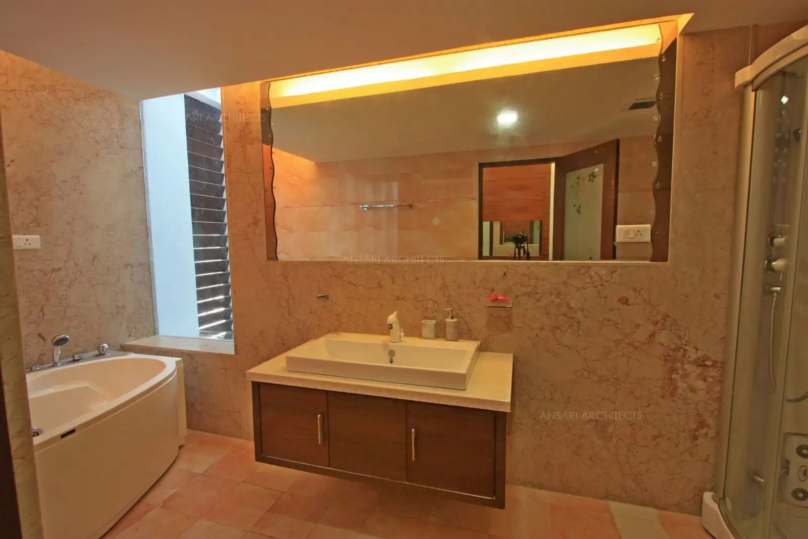 A large size mirror is used as the centre for a wider feel in this toilet of bedroom-2.