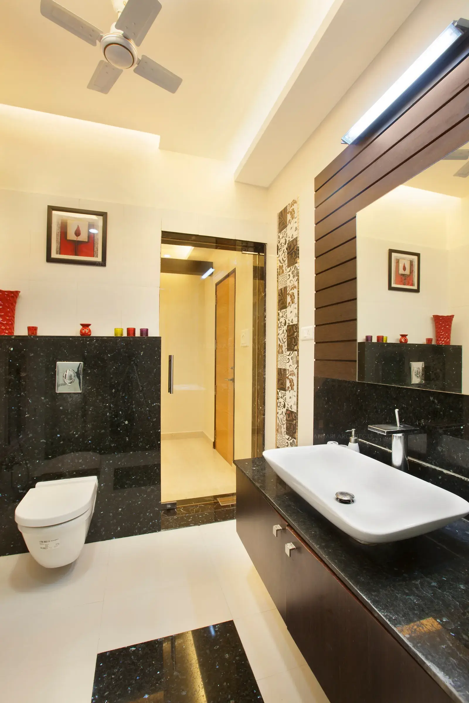 Toilet of daughter's bedroom is finished with wood and granite with floral high lights.