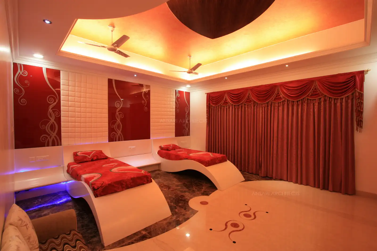 Kid's bedroom has been designed in customized curve shaped beds evocative of 'Ferrari cars' in PU finish with contrast painted glass on the wall.