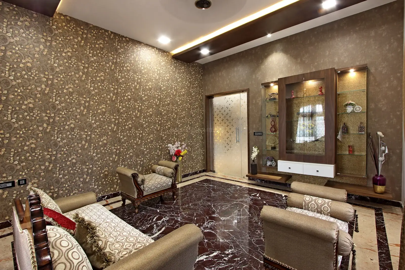 Wallpaper highlights one entire wall along the false ceiling and lights.