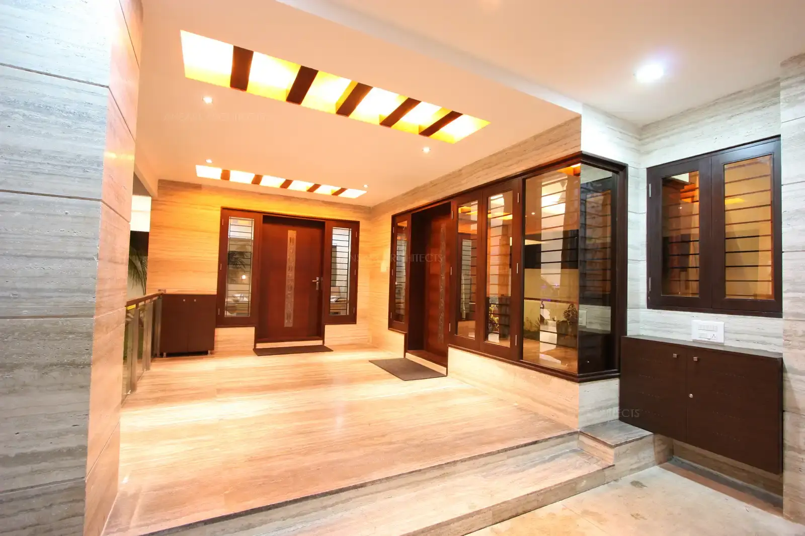 View of veranda and the main entrance which looks bold and bright with its false ceiling and conceal lights.