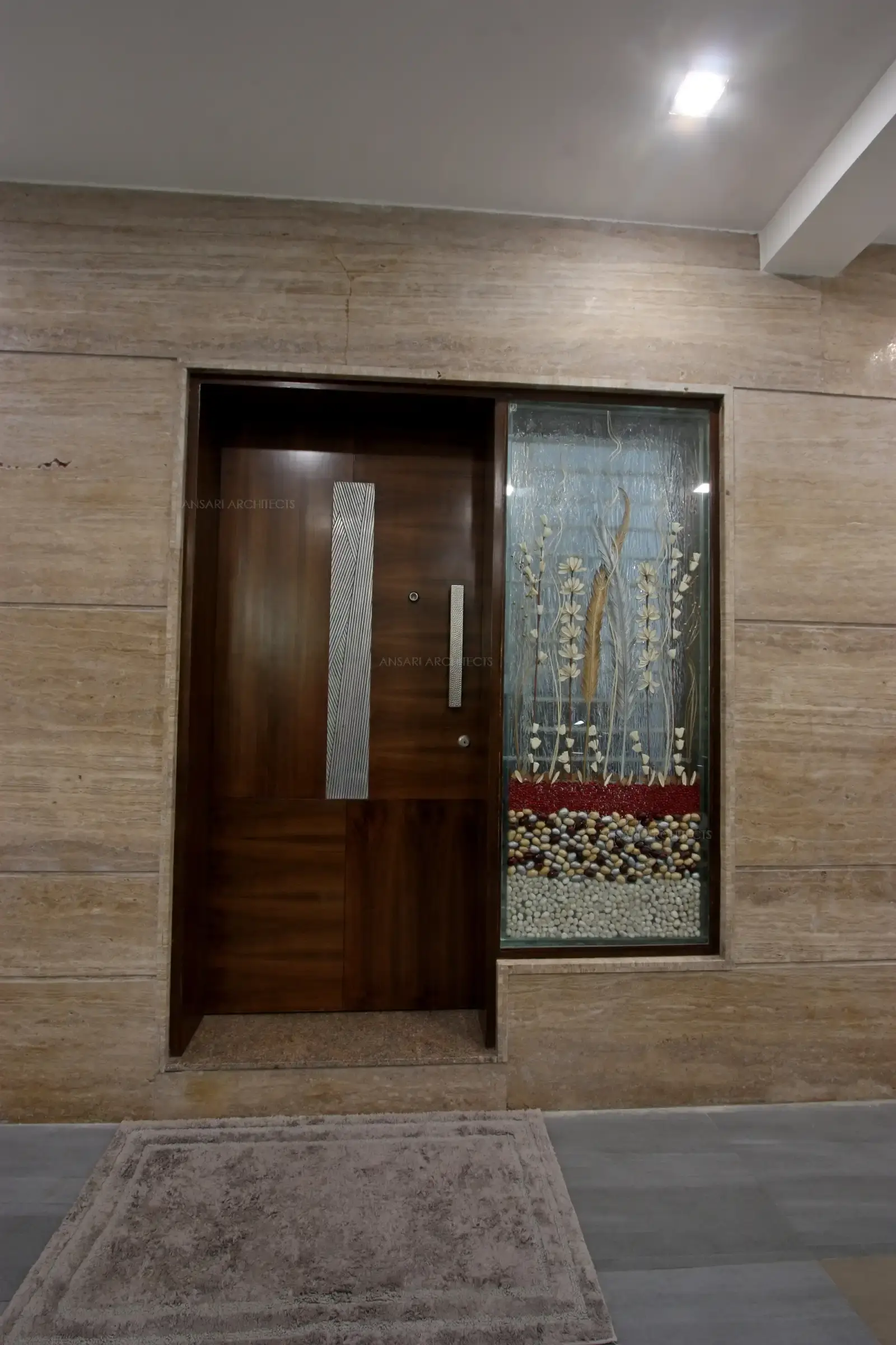 Main entrance with rich veneer flush door in combination with decorative fixed glass.