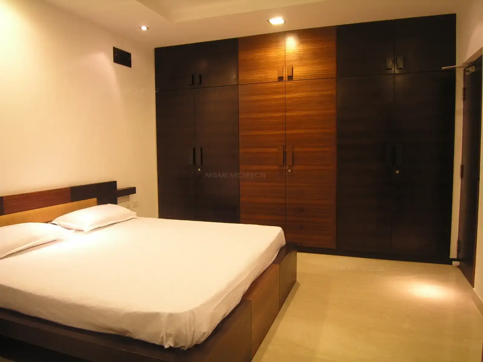 Wardrobe has been provided with lofts which is designed together in same pattern of rich dark veneer for a continues look.