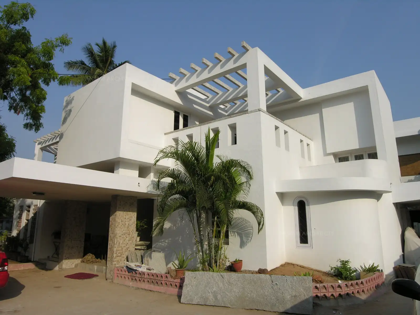 Simple lines and plain white finish define the remodeled exterior of the house.