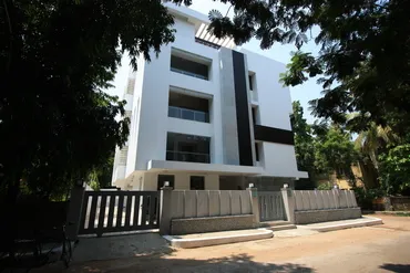 a building with a fence and trees
