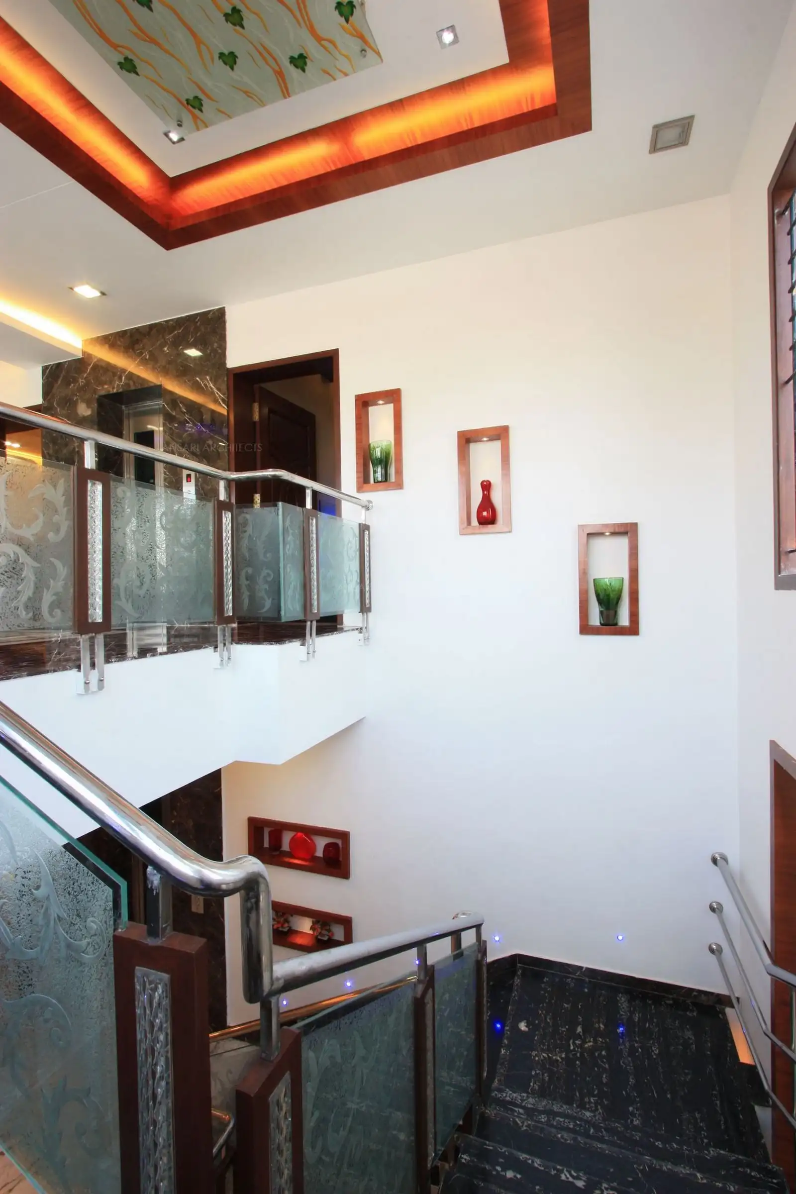 Niches have been given in the staircase wall to highlight the otherwise plain wall.