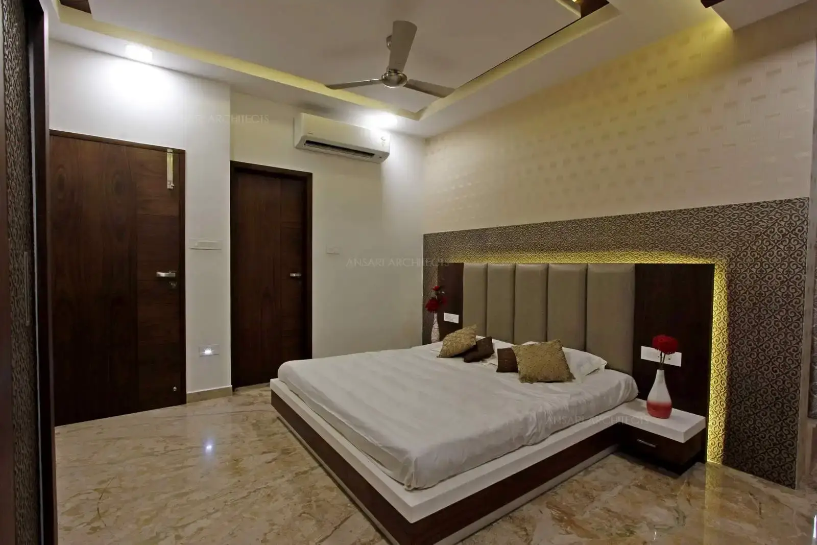 Solid wooden doors and the punctured wall texture keeps inspiring for an exaggerated luxury. The recessed lights provide soft glow and offers a warm counterbalance.