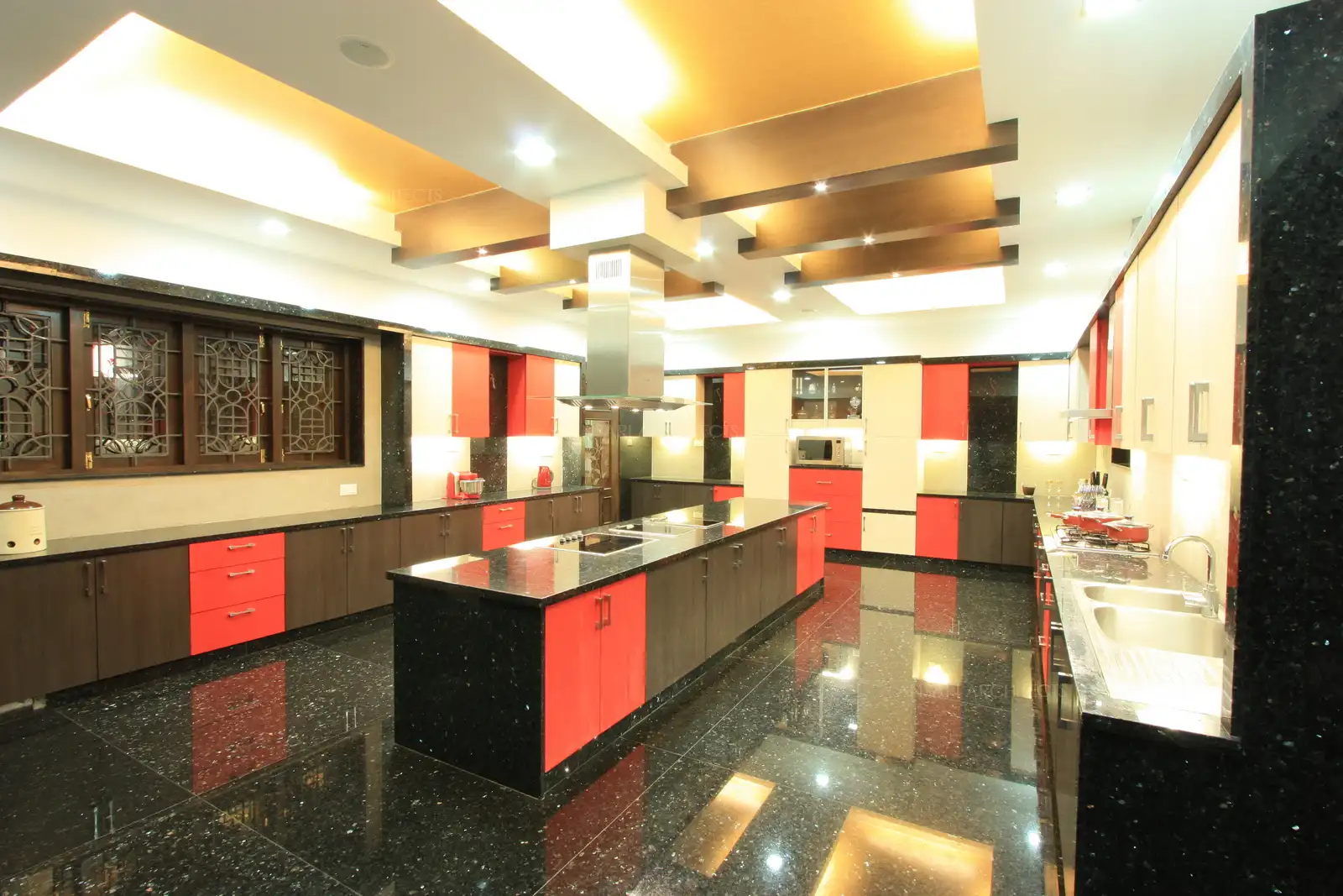 The spacious kitchen is designed in island counter with work areas smartly divided into differant funtional areas.