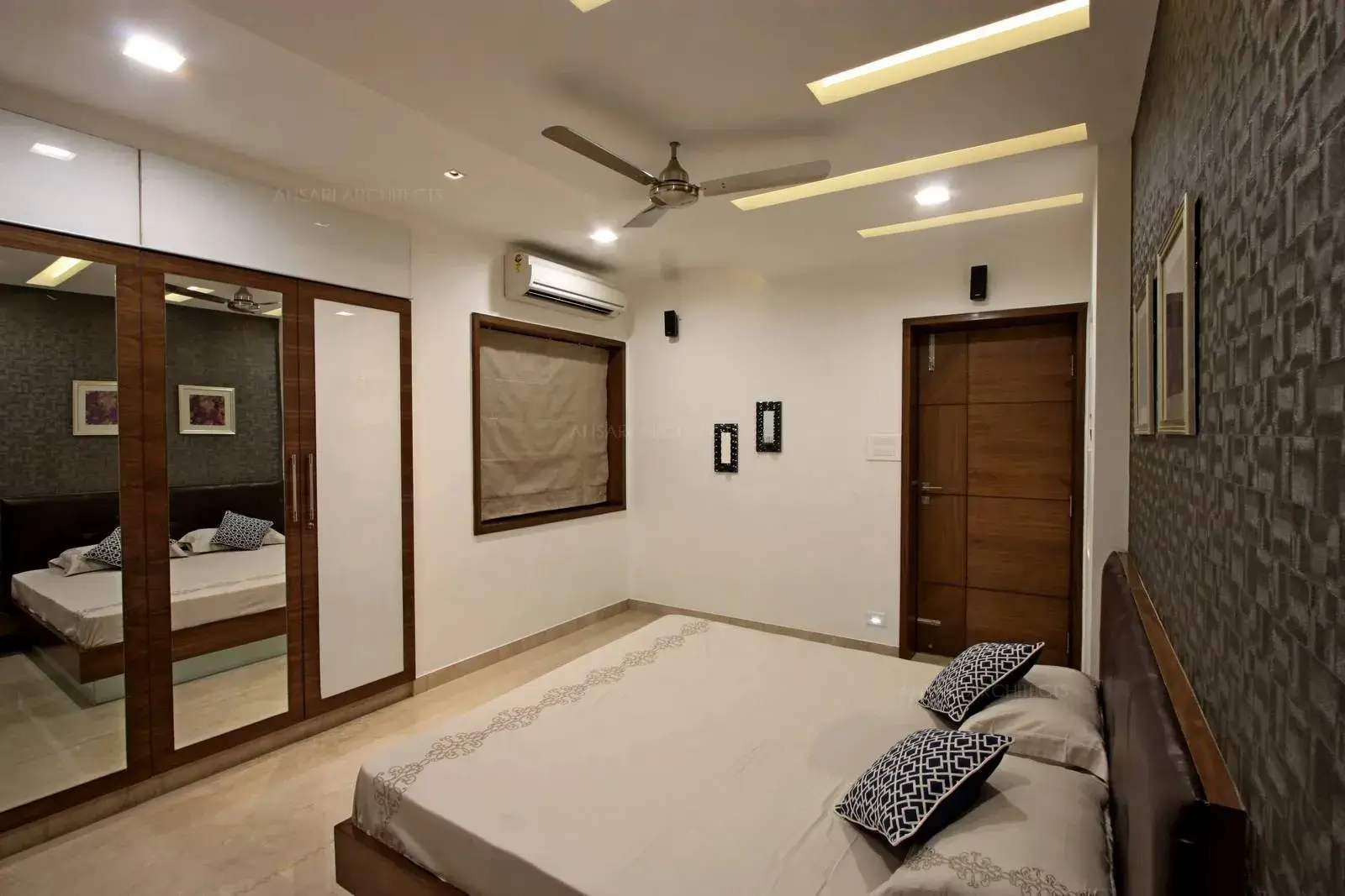 The rectangular cove lights are provided to bring out the false ceiling highlights and full height mirror cabinets are provided to create a contemporary bedroom.