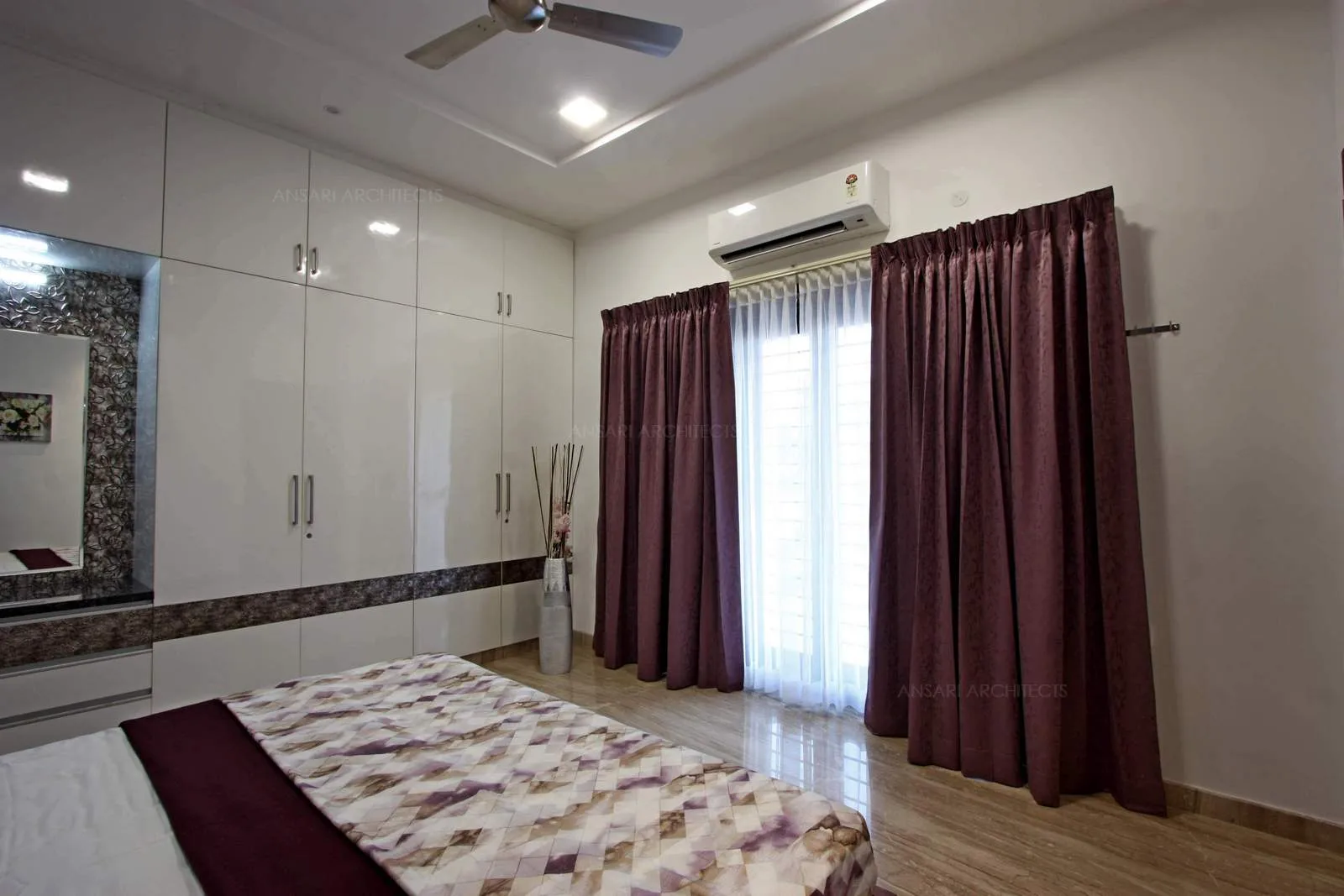 Luxurious and expansive bedroom, marble flooring accentuates the space, abundance of natural light streaming in through the window providing the bedroom a visual delight.