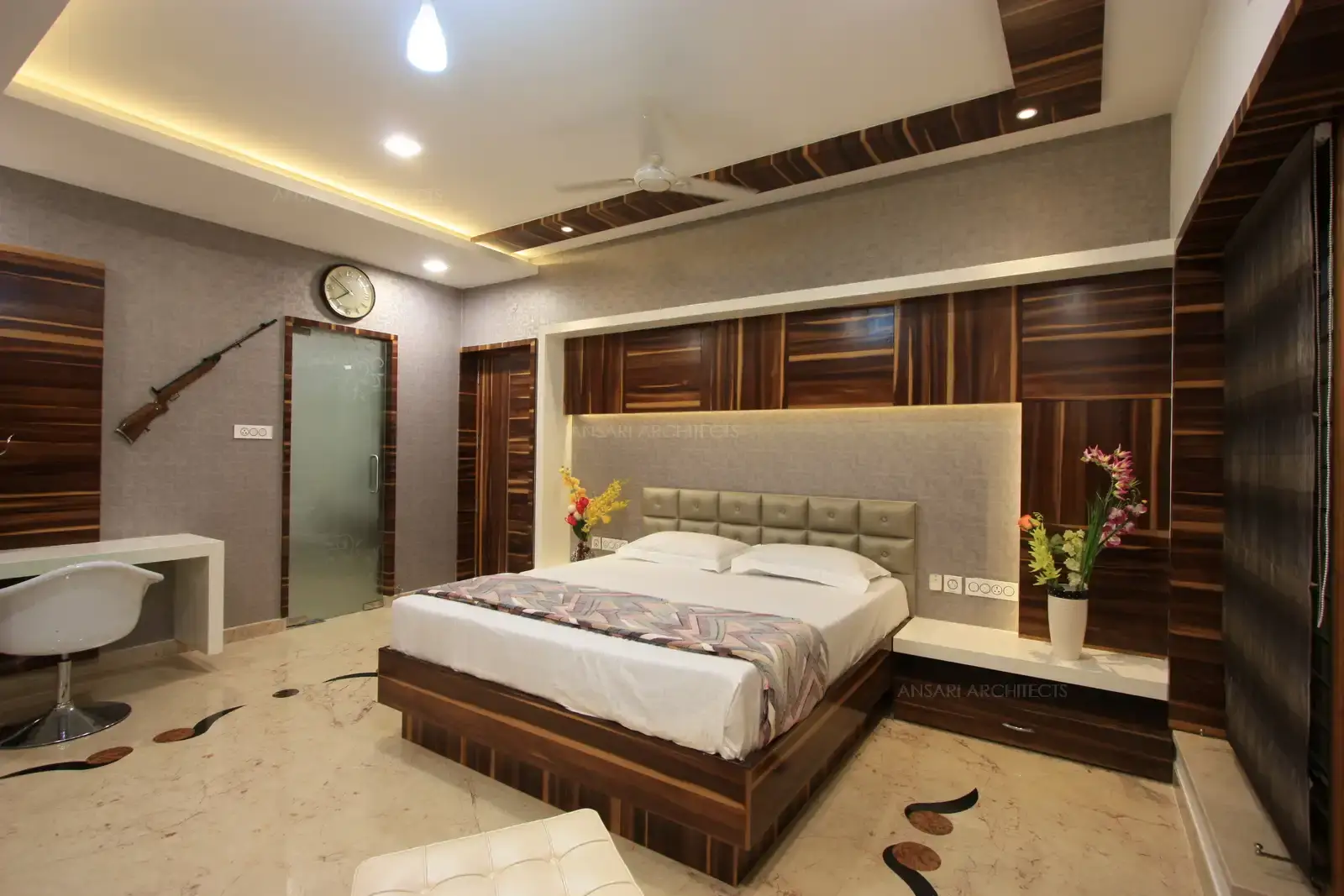 Wooden panelling and wall paper finishes highlights the bed area in son's bedroom.