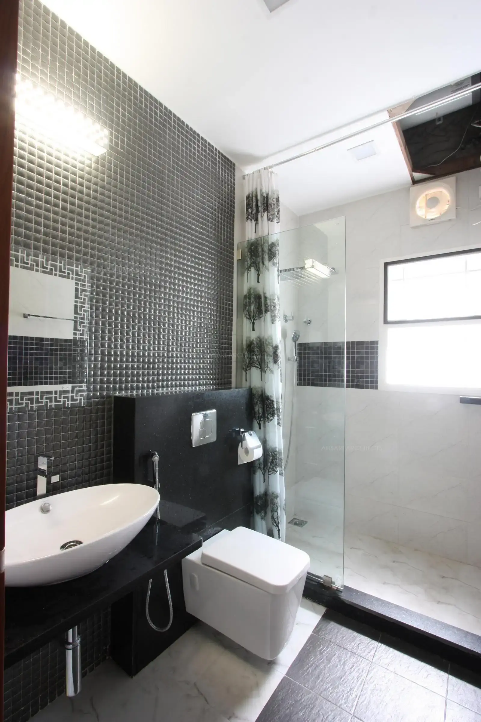 Elegant classic white tiles gives a bathroom a sense of polish and luxury. A streamlined modern vanity the neutral bedroom scheme is continued here with standalone shower area with glass partition.