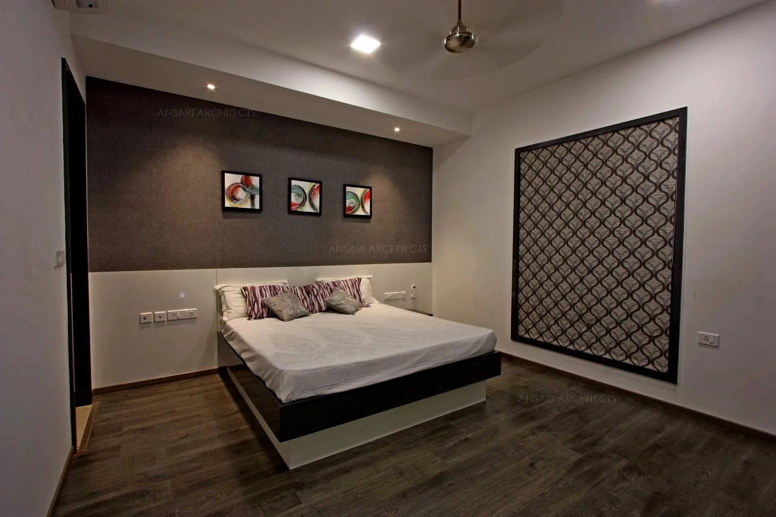 The patches of grey splashed around the room, grey texture provides a perfect base for the vibrant layout and the window covered with jaali patterned effect.