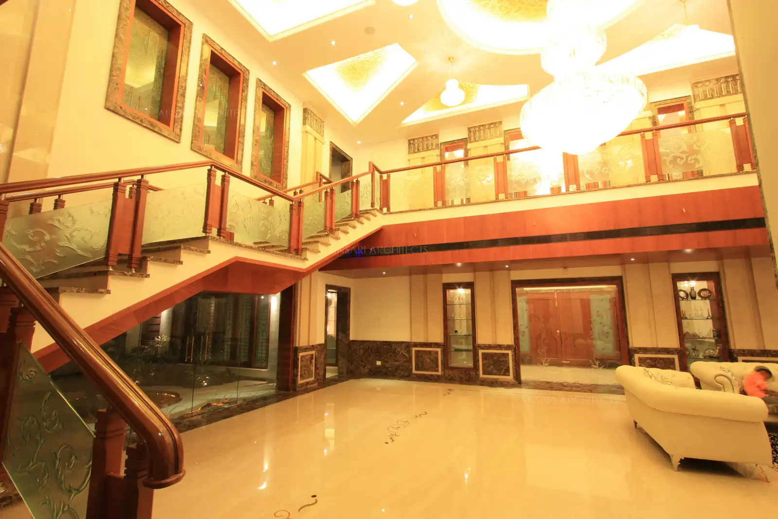 View of living room showing the double height ceiling, wall cladding and rich handrails.