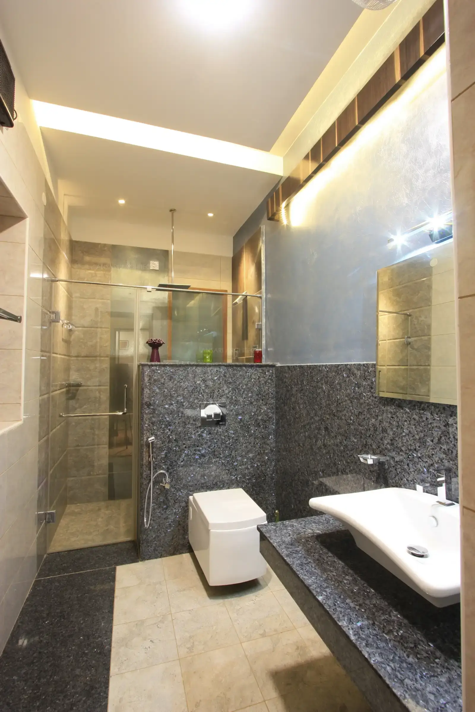 Bathroom of son's bedroom has shades of grey in the form of tiles and granite.