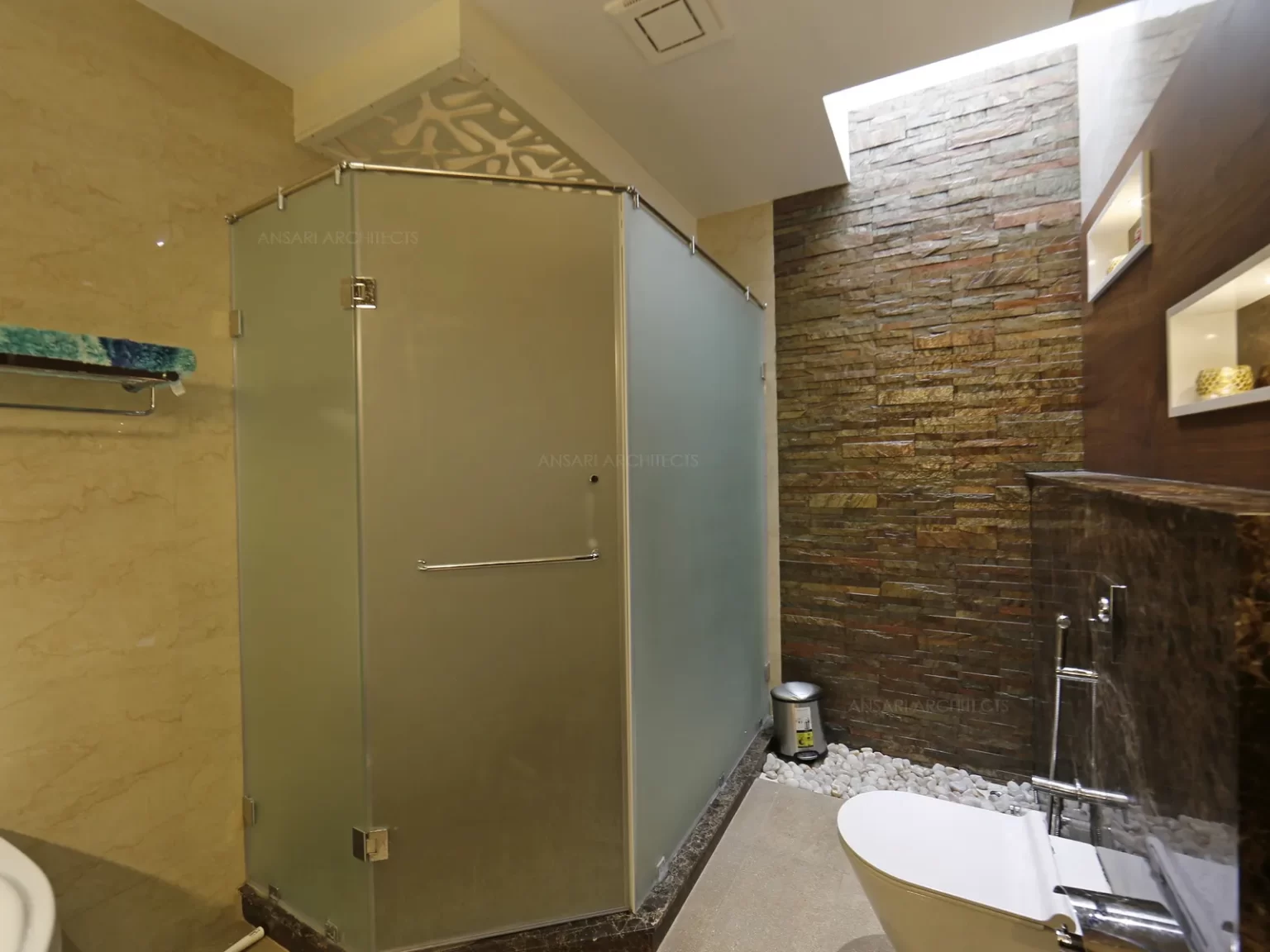The glass panels and the sumptous stone textures with ceiling decorative panel lights and niches offering a modern look.