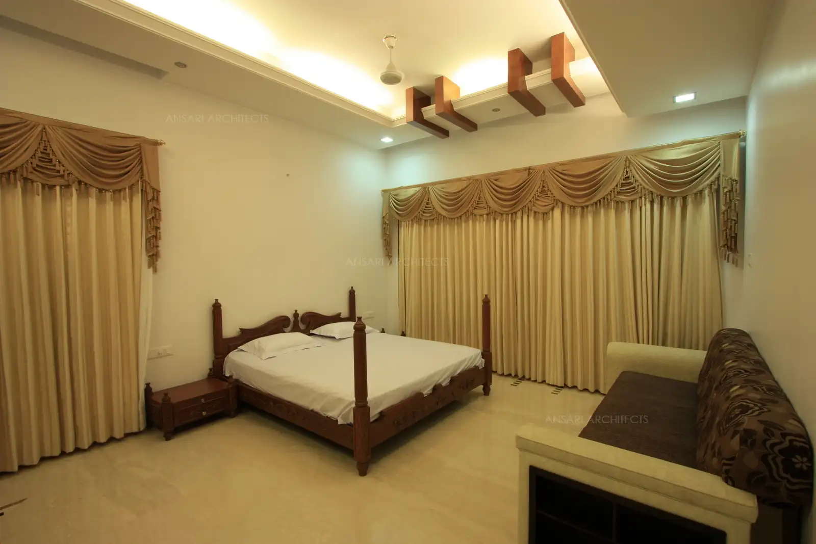 Guest bedroom 2 is designed in antique style with intricate wooden carving.