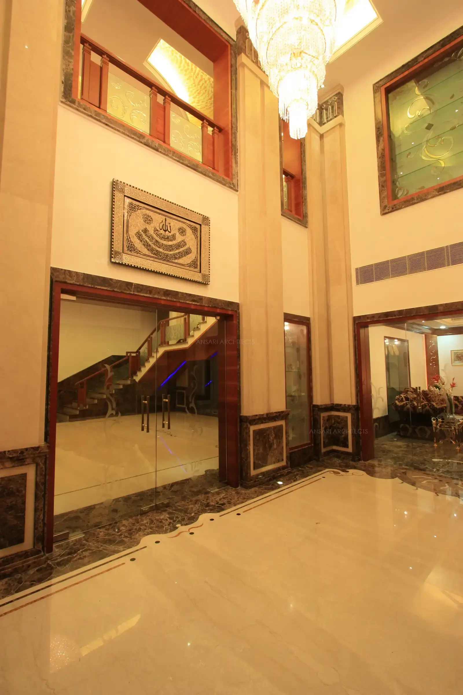 Double height ceiling in the lobby has a grand chandlier which gives a bright and royal look to the area.