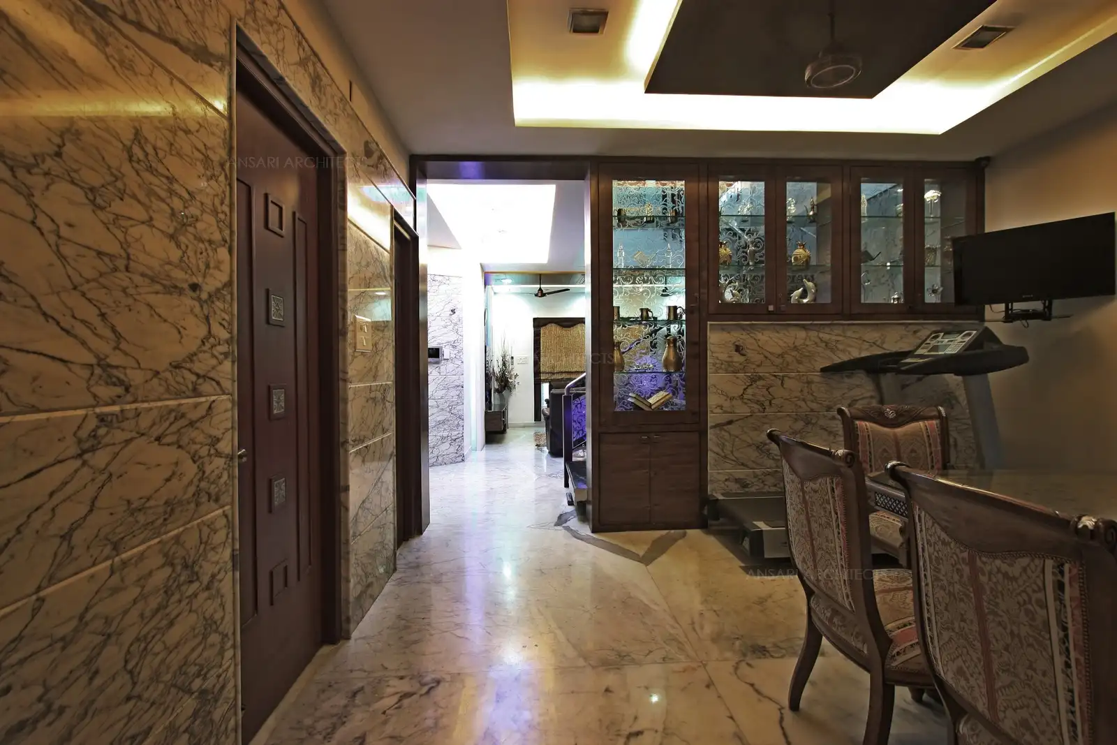 A display unit acts as a partition for the staircase wall from the dining room