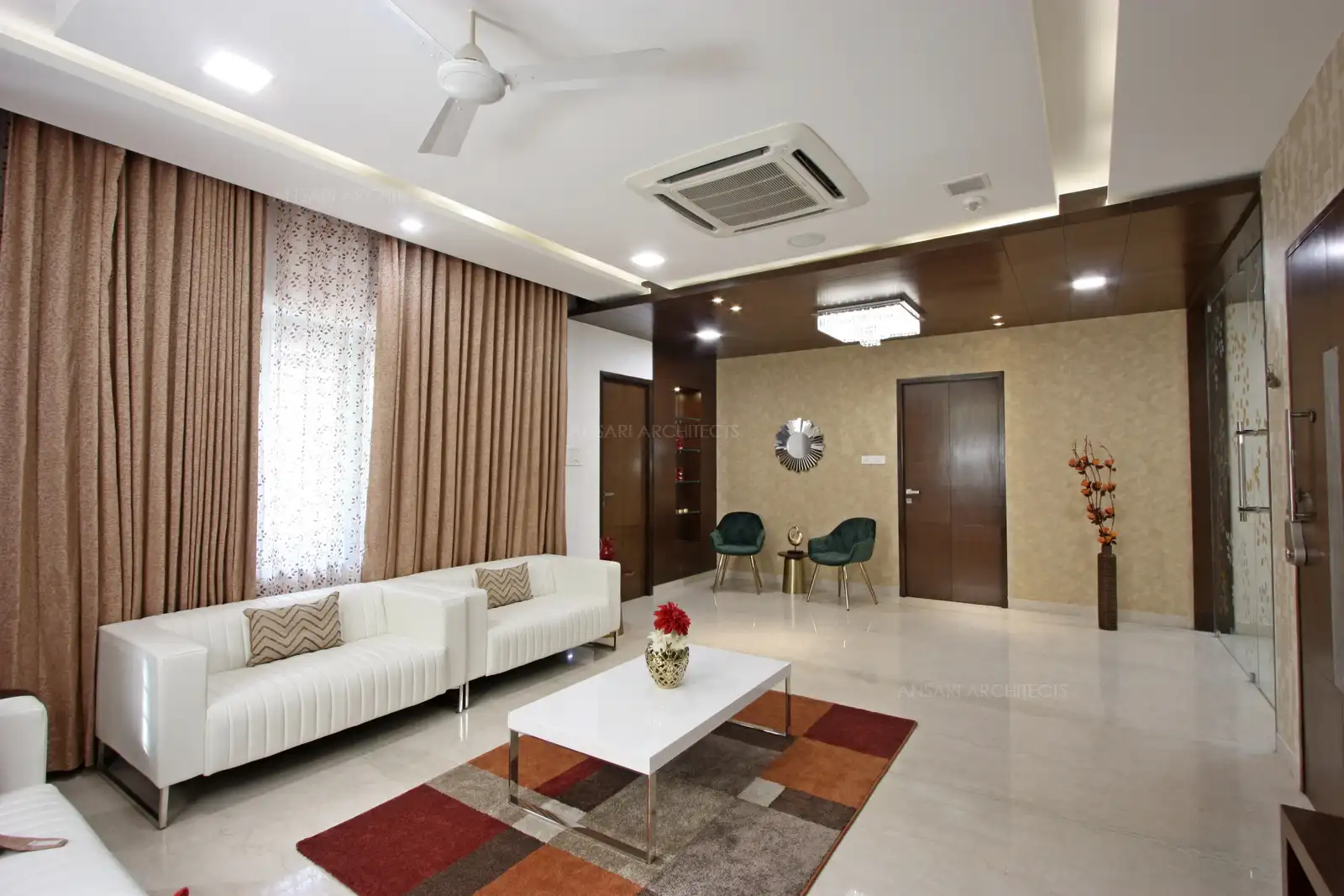 The living room has been designed with large glass window and artificial lights embellished with wooden ceiling and marble flooring and the entire space remains to be a very-warm welcoming space.