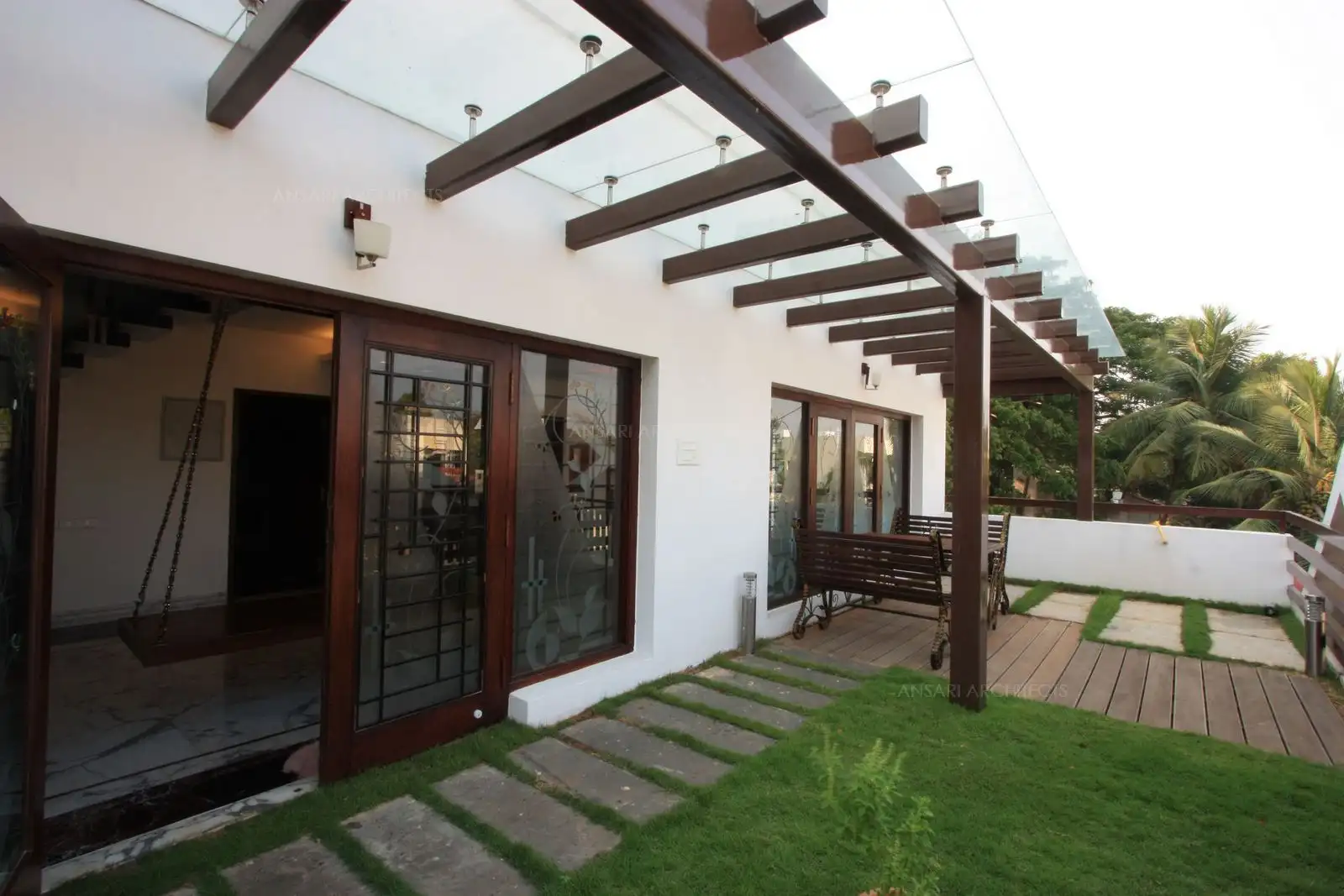 Terrace garden in the second floor has wooden deck with stone pathways.