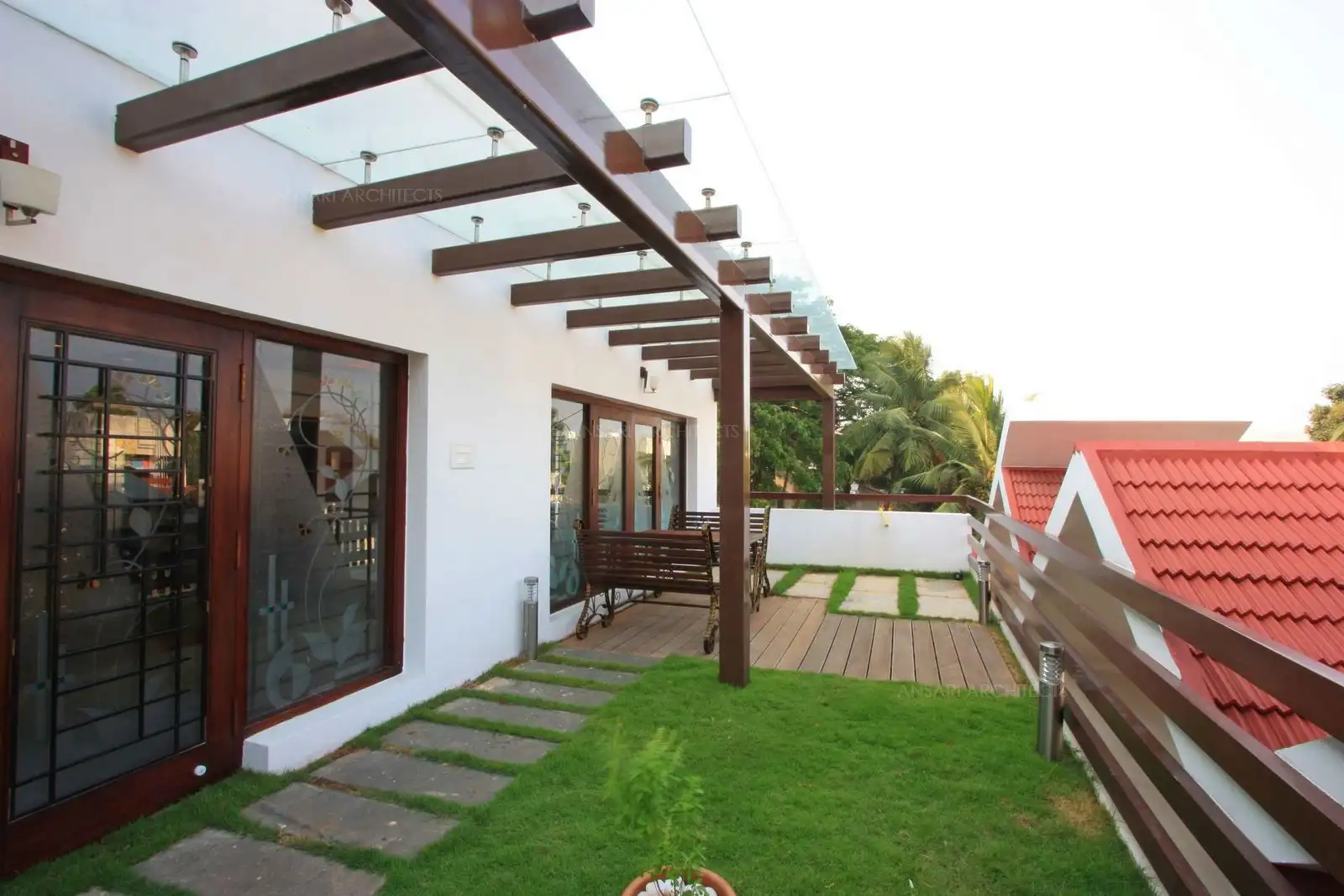 Wooden pergolas covered with glass has been provided in the terrace garden for shaded seating.