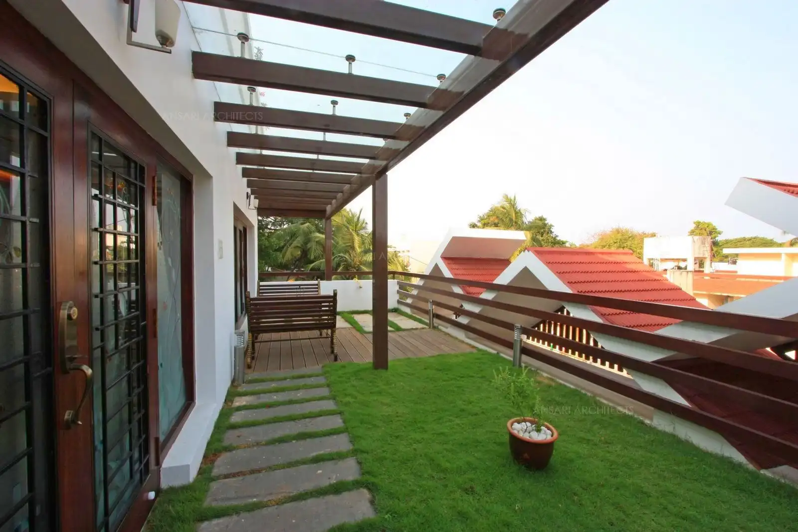 Slope roof given for exterior aesthetic view also serves as privacy factor in this terrace garden.