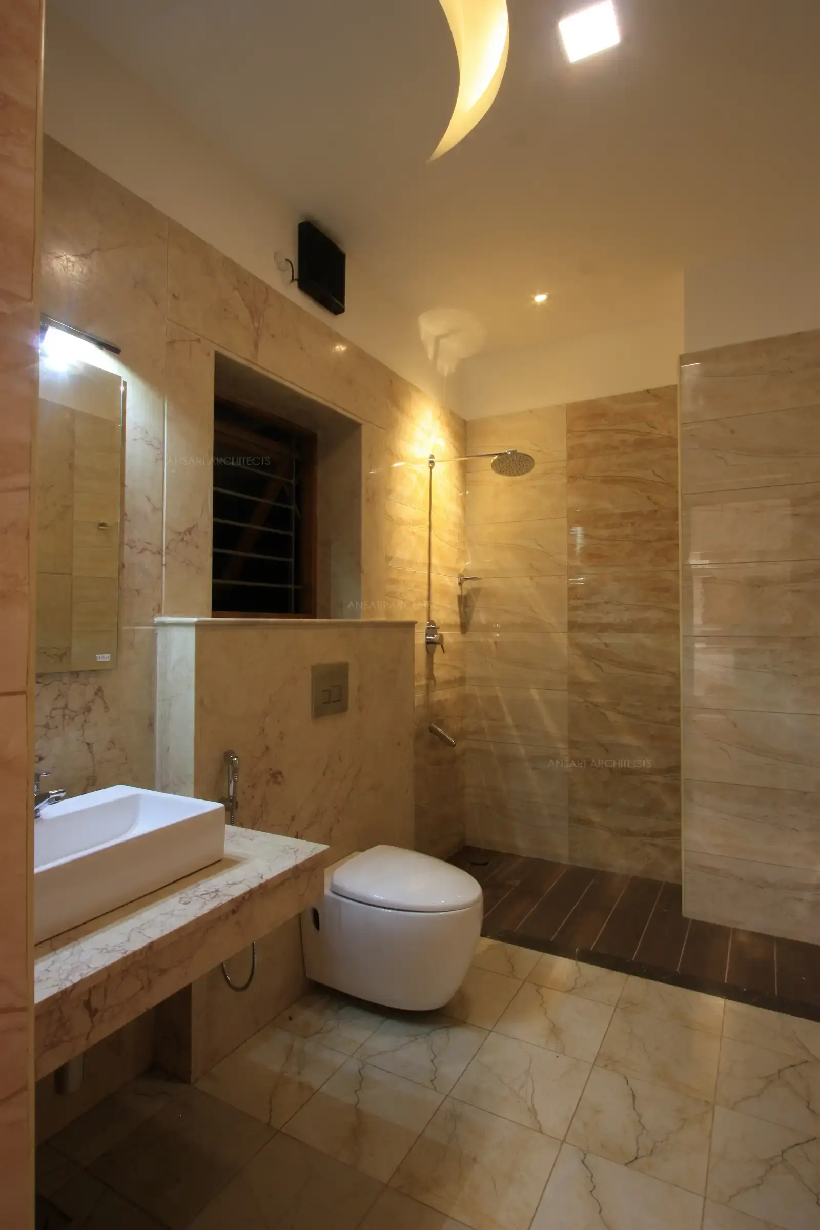 The toilet in the bedroom 5 has a single shade of beige throughout the bathroom to give it a spacious and open look.
