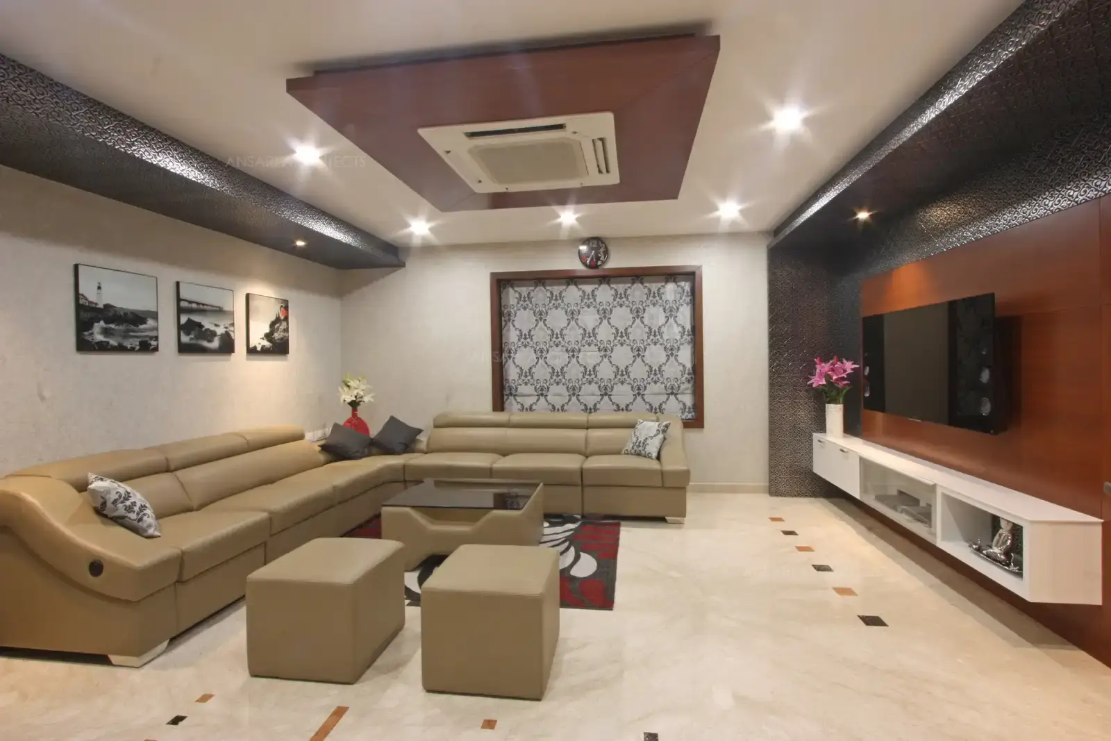 Walls are highlighted with accessories and photographs, white ceiling and the wooden highlight for the air conditioner creates a charm. The wall panelling forms a ideal backdrop for the entire space and acts as a focal point.