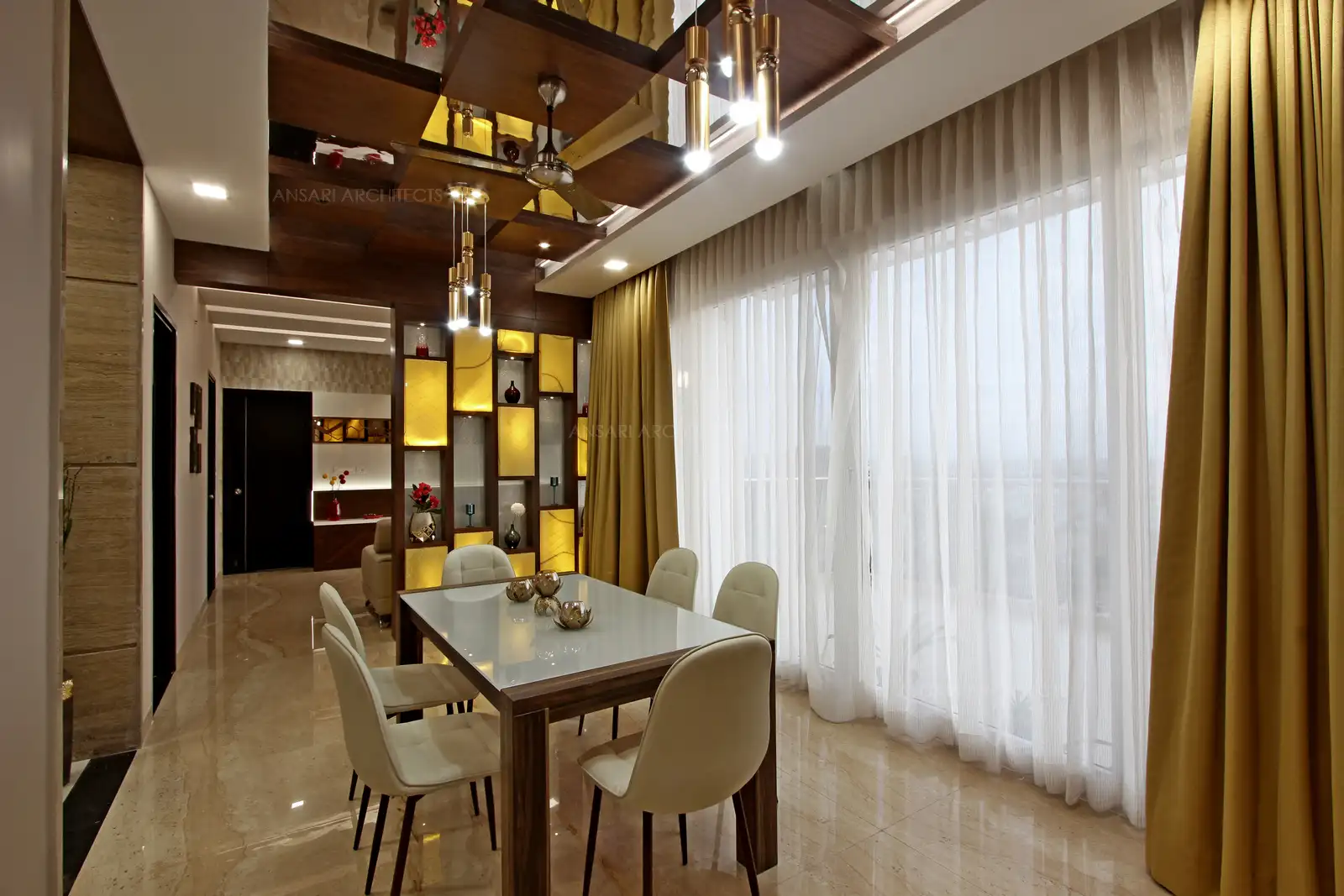 Curtains layer the drapes creates an interesting blend of gold for a sense of visual interest, the marble flooring merges along with the walls and curtains bring in a sense of luxury.