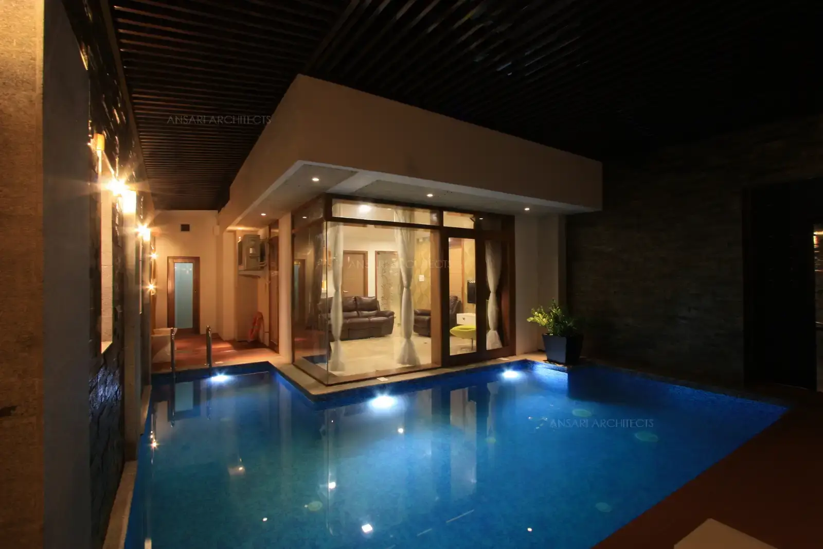 The drawing room in the ground floor has been designed as a floating room surrounded by water body on two sides.