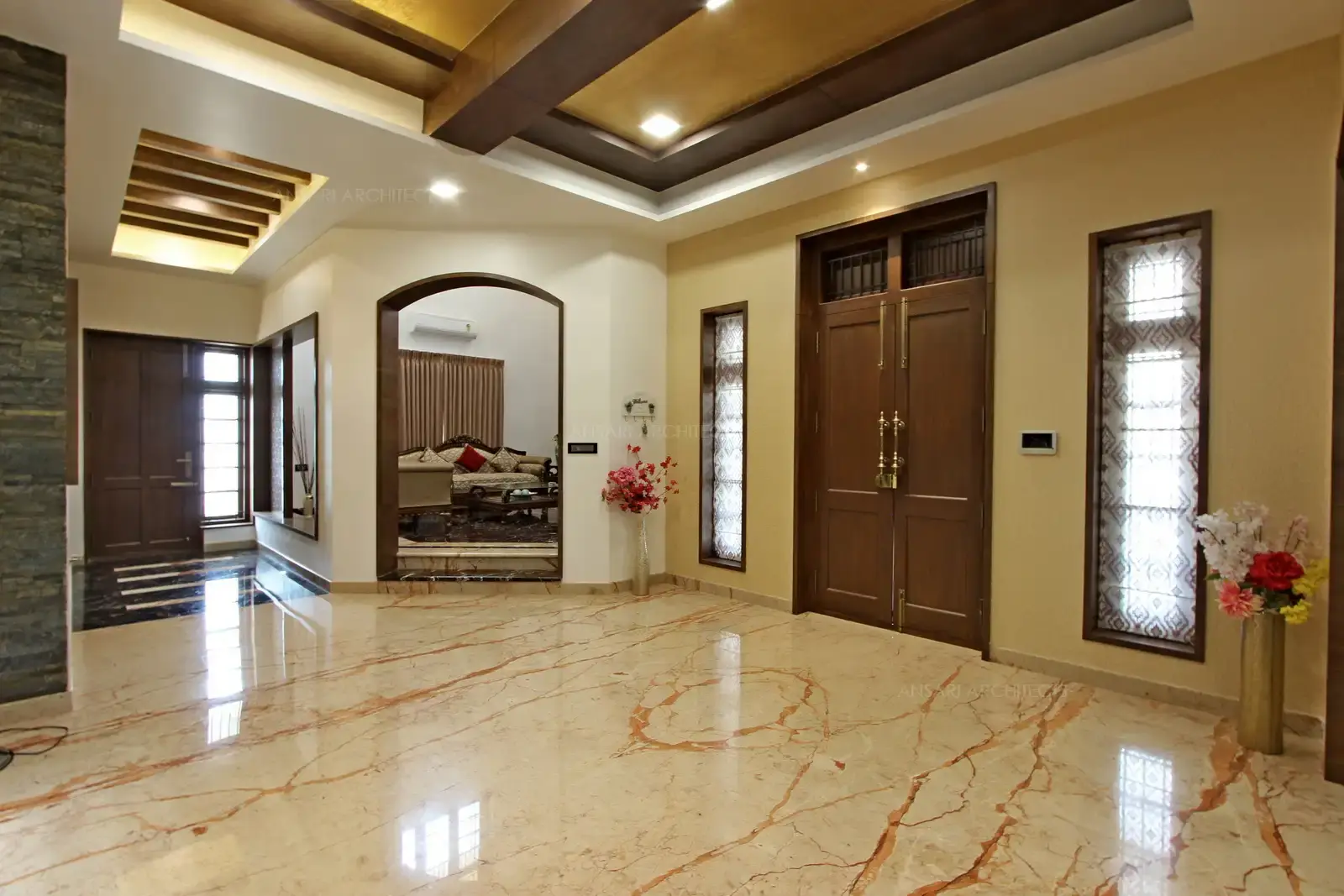 Soothing walls and floor gets golden touch from the recessed lighting of the space. More depth is brought through the false ceiling of thehouse