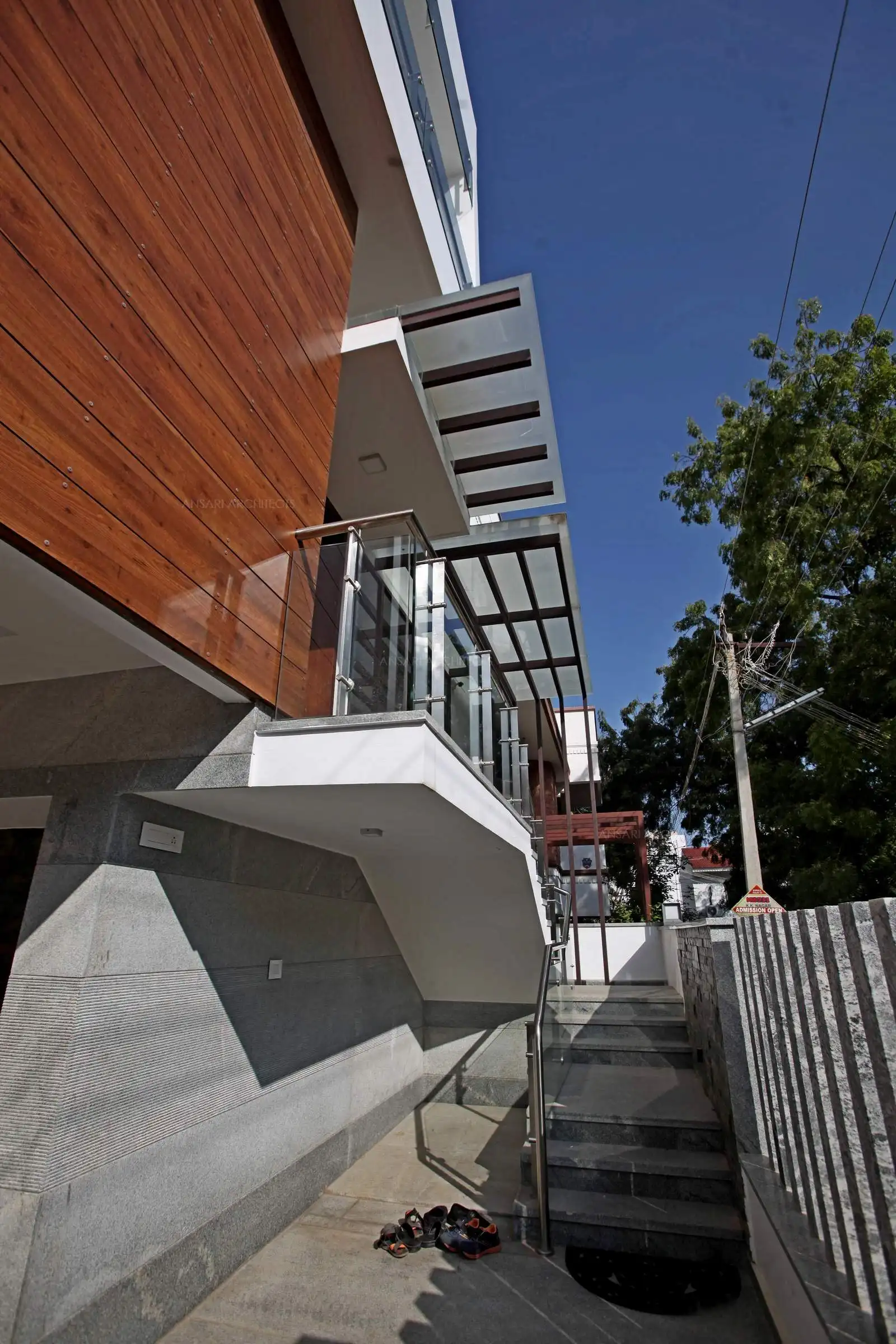 The exterior entrance through the staircase. The facade expresses grandeur and prestige. The rock cut compound wall features a structural effect.