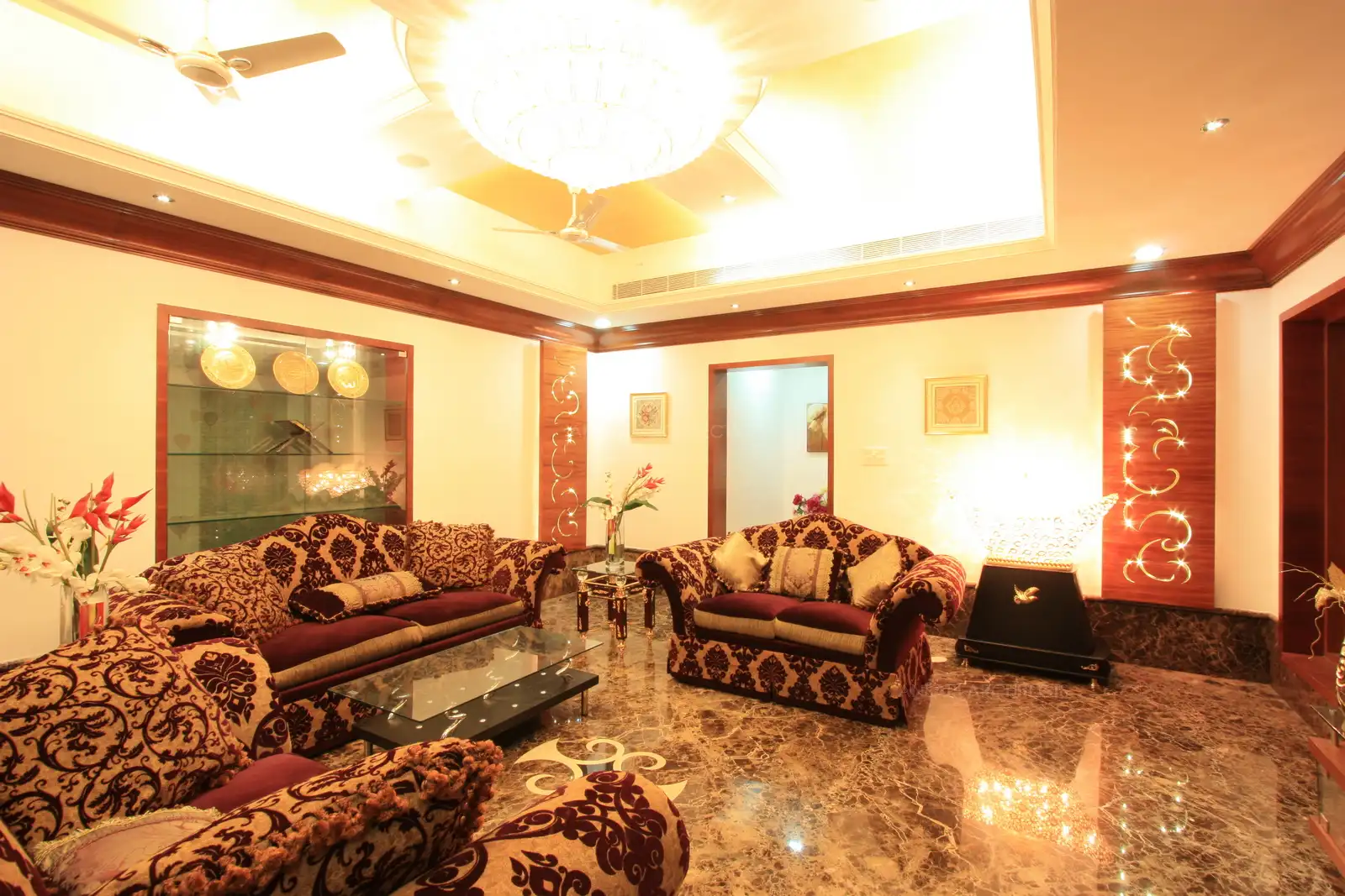 Chandlier above, concealed lights and decorative lights are used to bright out the richness of Dark Emperador marble flooring.