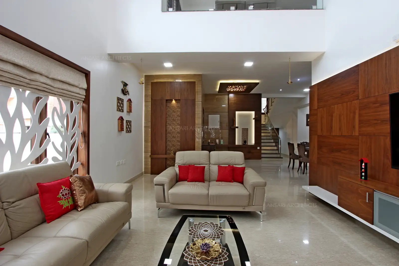 Double height space and unique lights highlight the design, the accent wall acts as the focal point cladded with veneer and decor elements emphasize the elements.