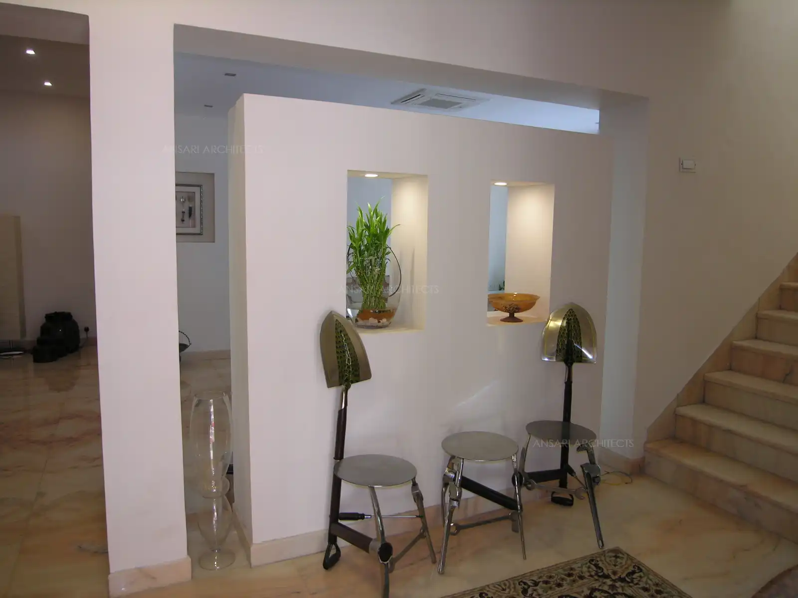 Solid wall remodeled in the lobby with niches and opening for a contemporary look.