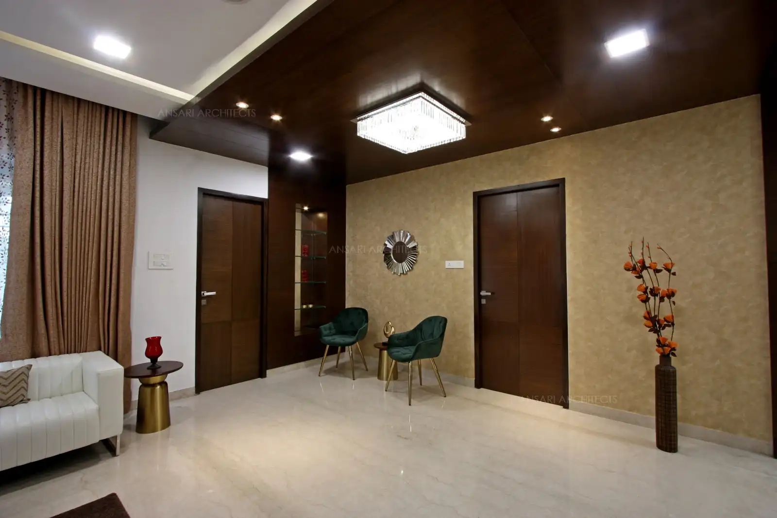 Wooden false ceiling at the living room gives a warm feel with furniture complementing the space. All elements are seamlessly blended to lend a holistic modern appeal.