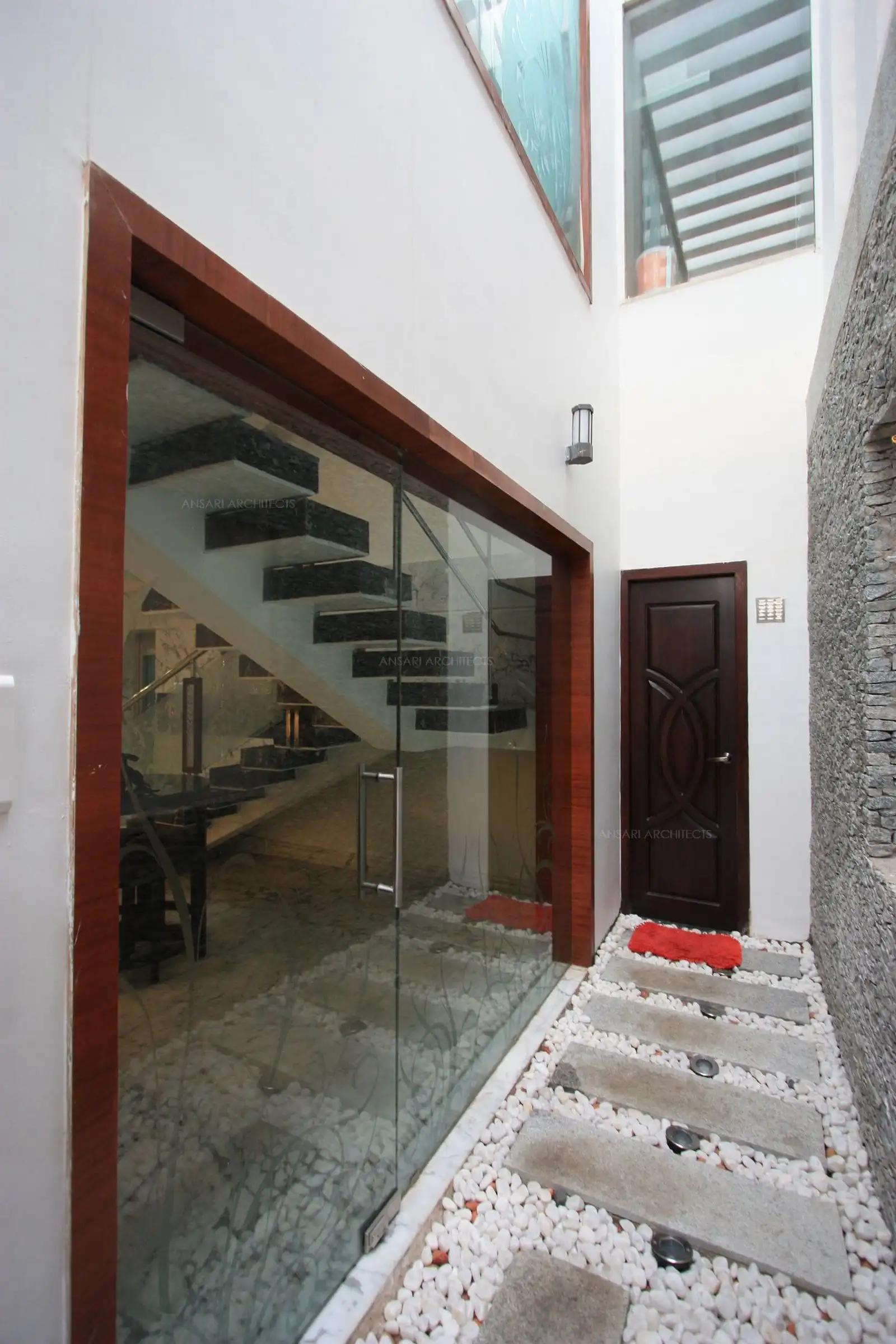 The courtyard which is seen from drawing and living room has pebble and stone flooring provided with floor spot lights.