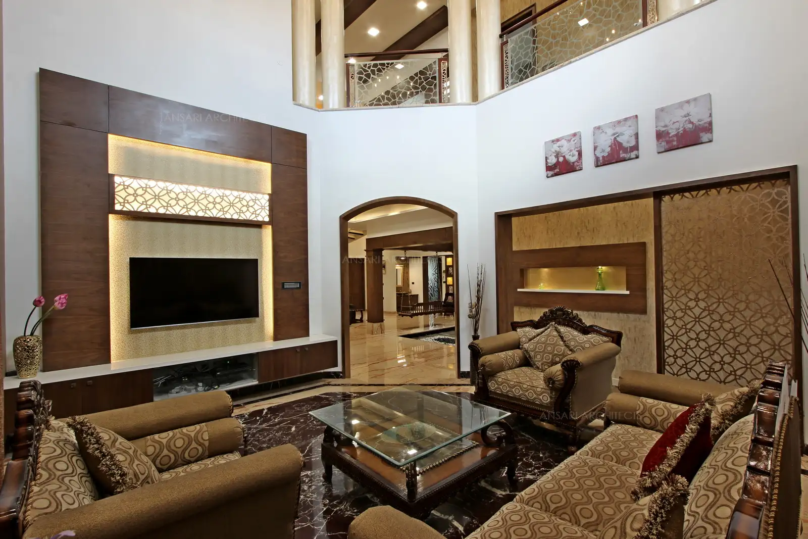 The TV unit looks elaborate with veneer panelling and strip lights highlight the unit.
