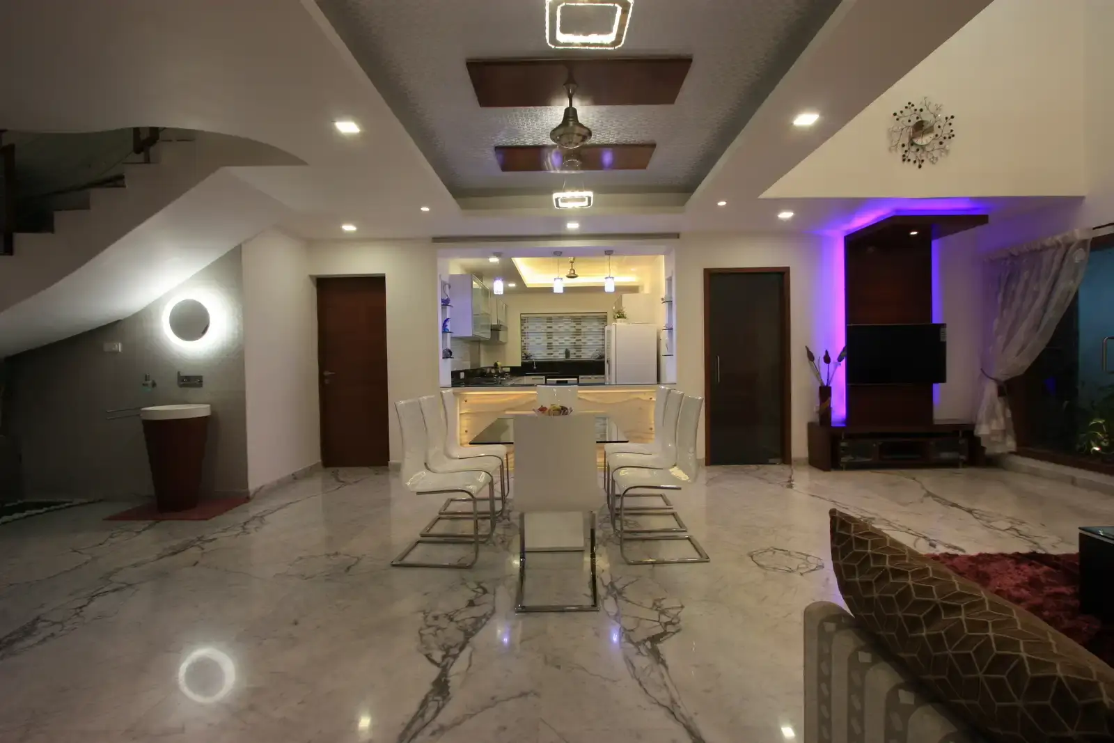 False ceiling in the dining area has been specially designed to create a focal point with silver wall paper, wooden inserts and hanging lights.