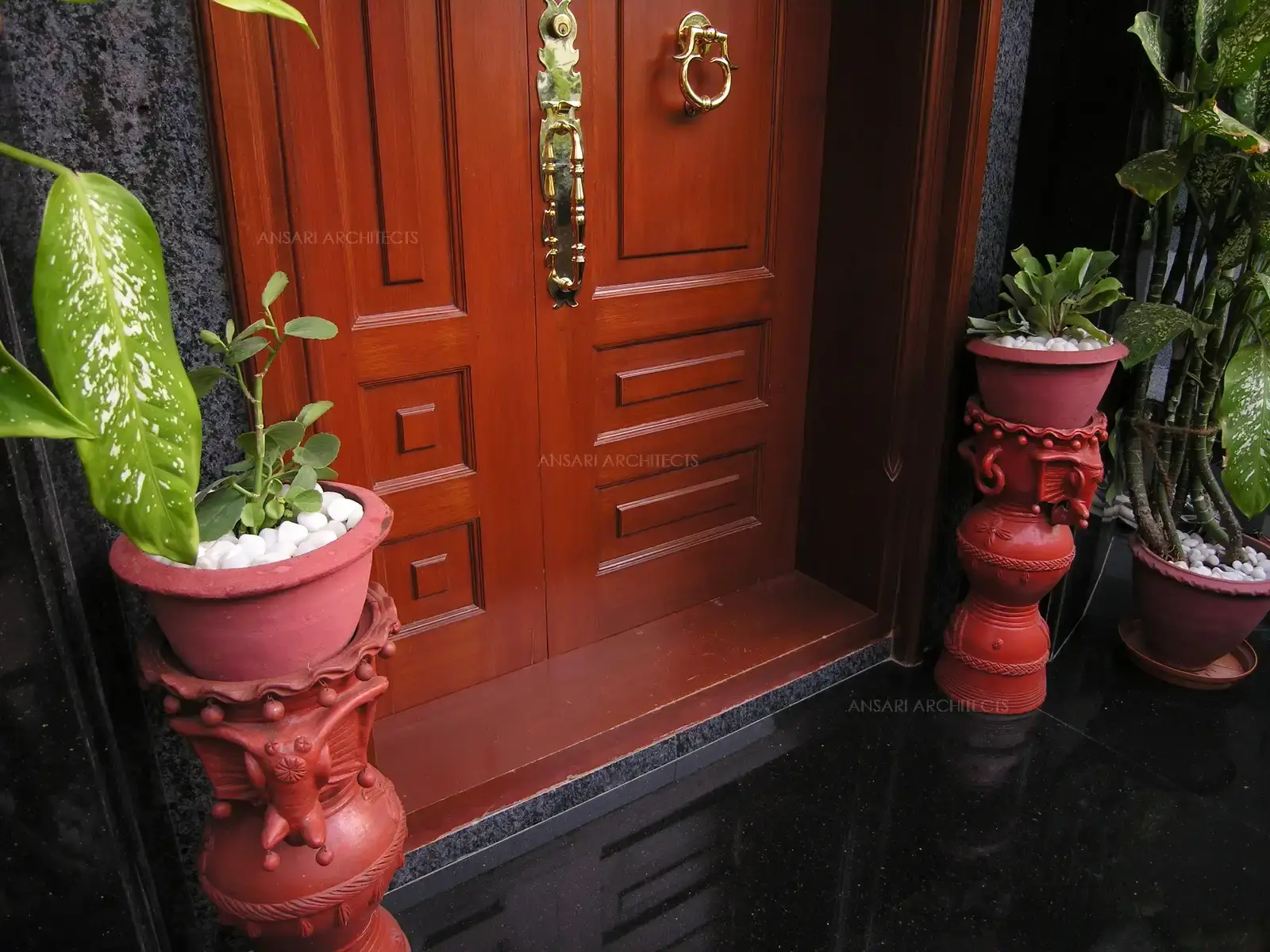  The main door finished with authentic Teak wood evokes the olden day, traditional wooden doors of South India with brass handles and knocking ring.