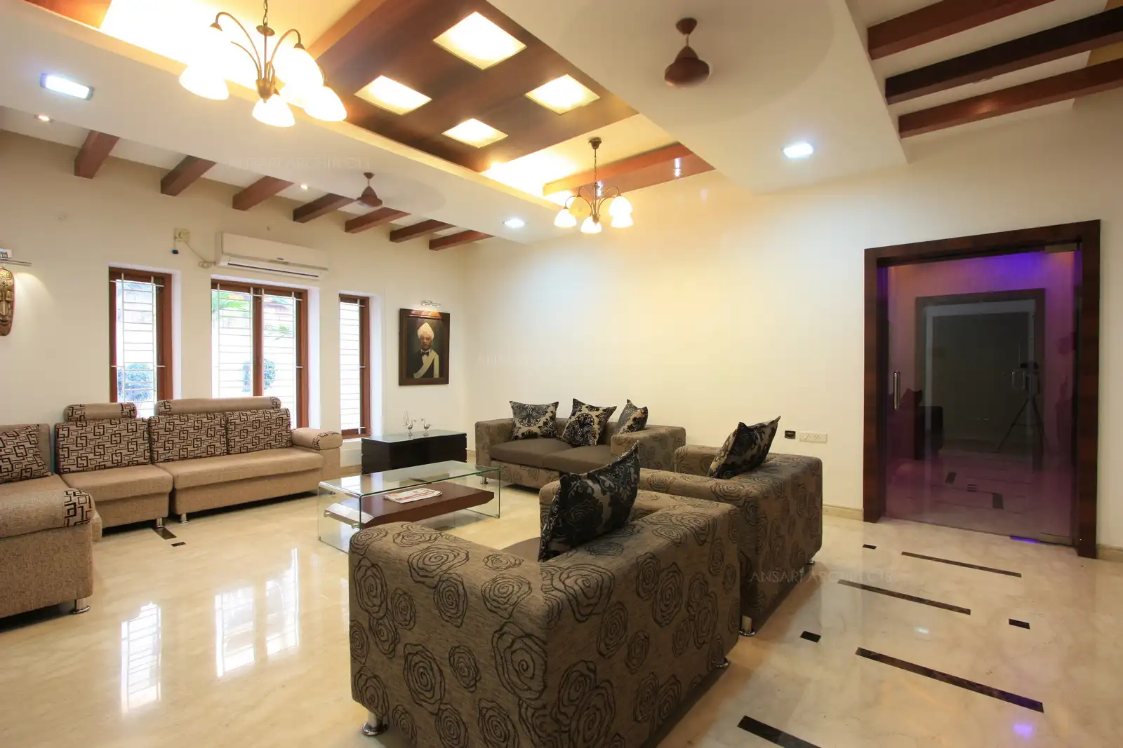 In this angle, you see the glass door leading to the corridors, which lead to rest of the rooms in the backside of the house. The windows on the left side overlook the side set back garden.