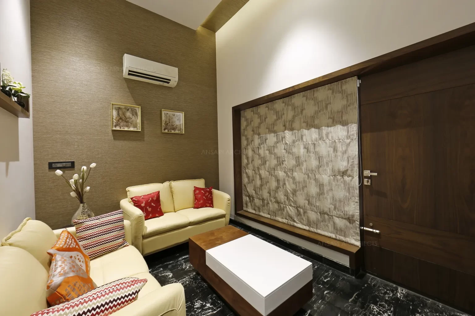 The reception area reflects luxury theme featuring dark tones of wood and elegant aura for the furniture design of the space.