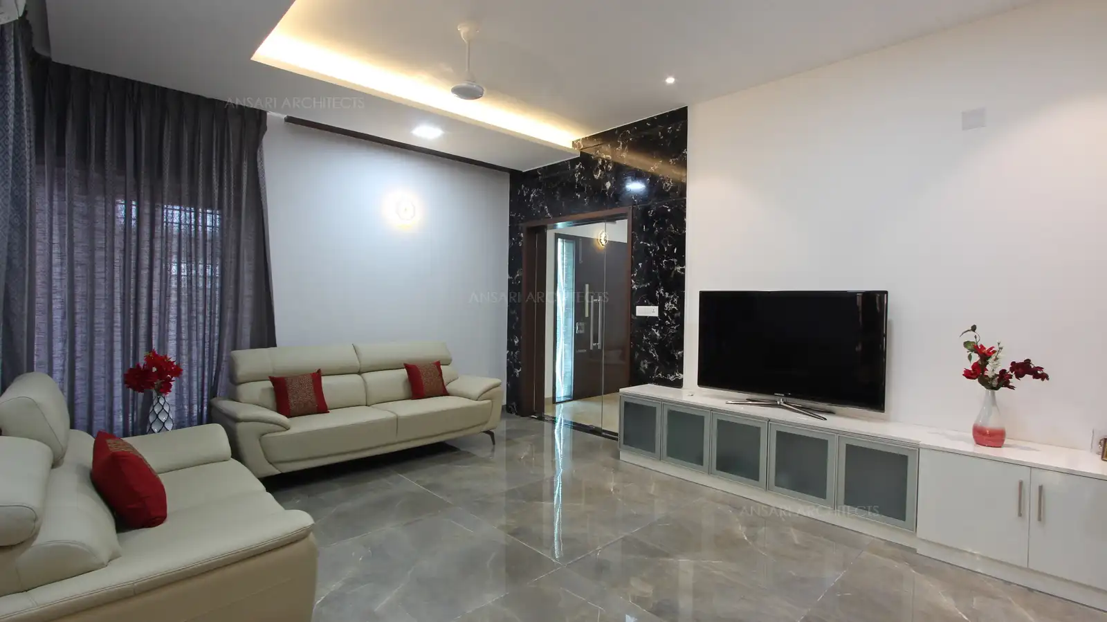 The off-white cushion offers a more textural touch with the all white backdrop with recessed lights in the ceiling which remains as a key for warm details, TV unit looks classy and uncluttered with functional units.