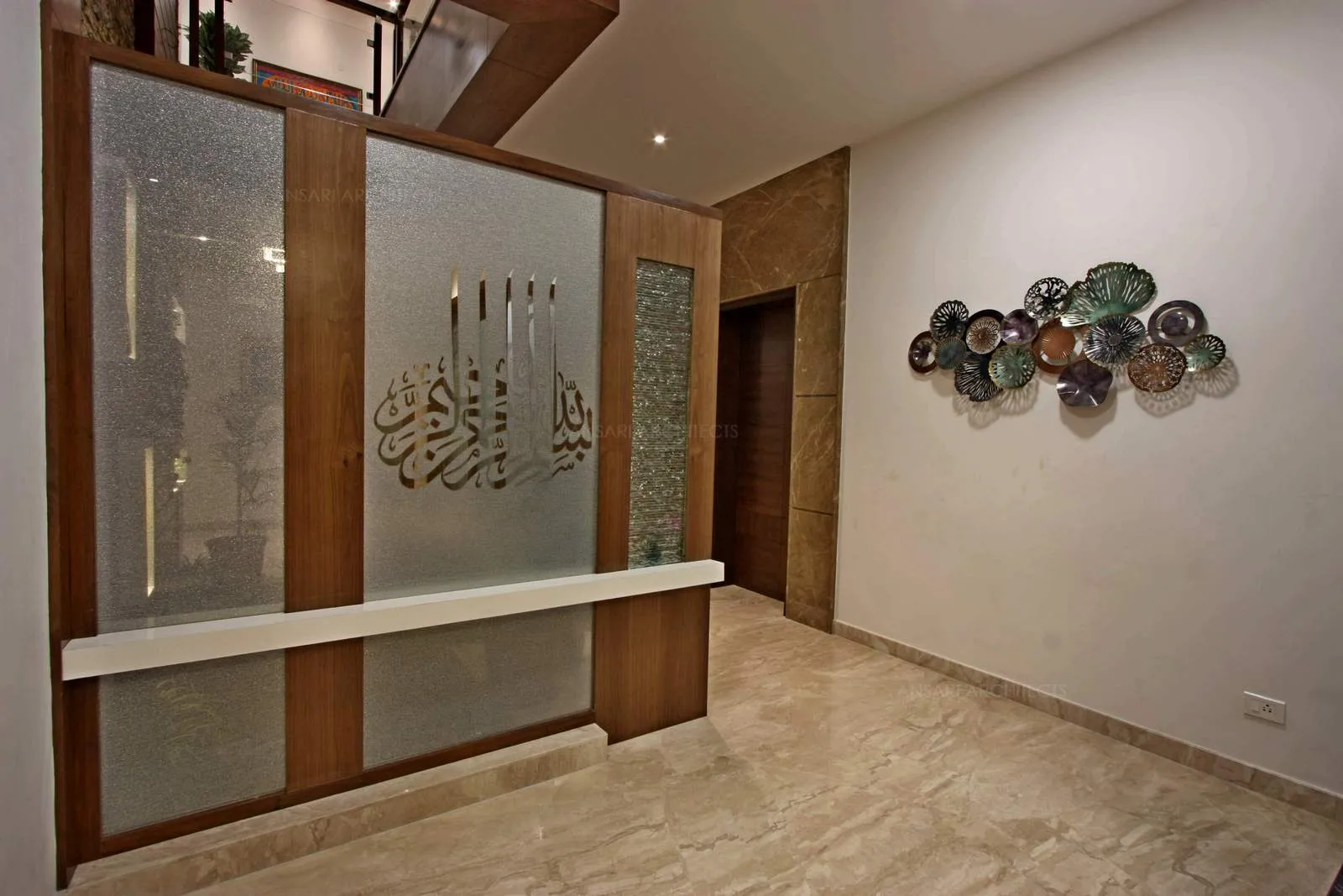 The beautiful display of artefacts on the wall, the islamic inscription on the glass panel takes the space as a focal point for the space.