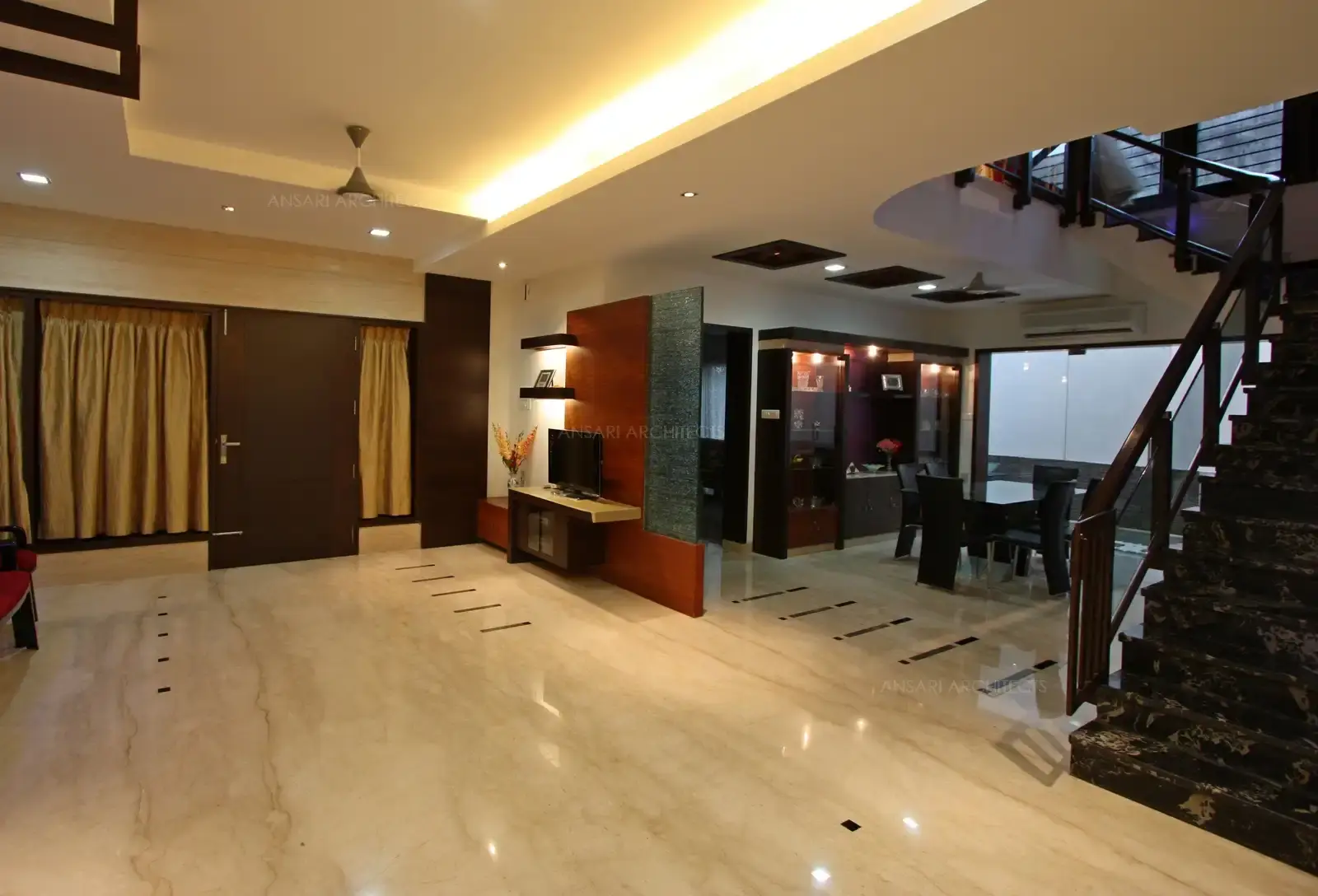 Living and dining rooms have a light colour marble with similar marble cladding on the walls giving a very spacious look to the over all interior of the house.